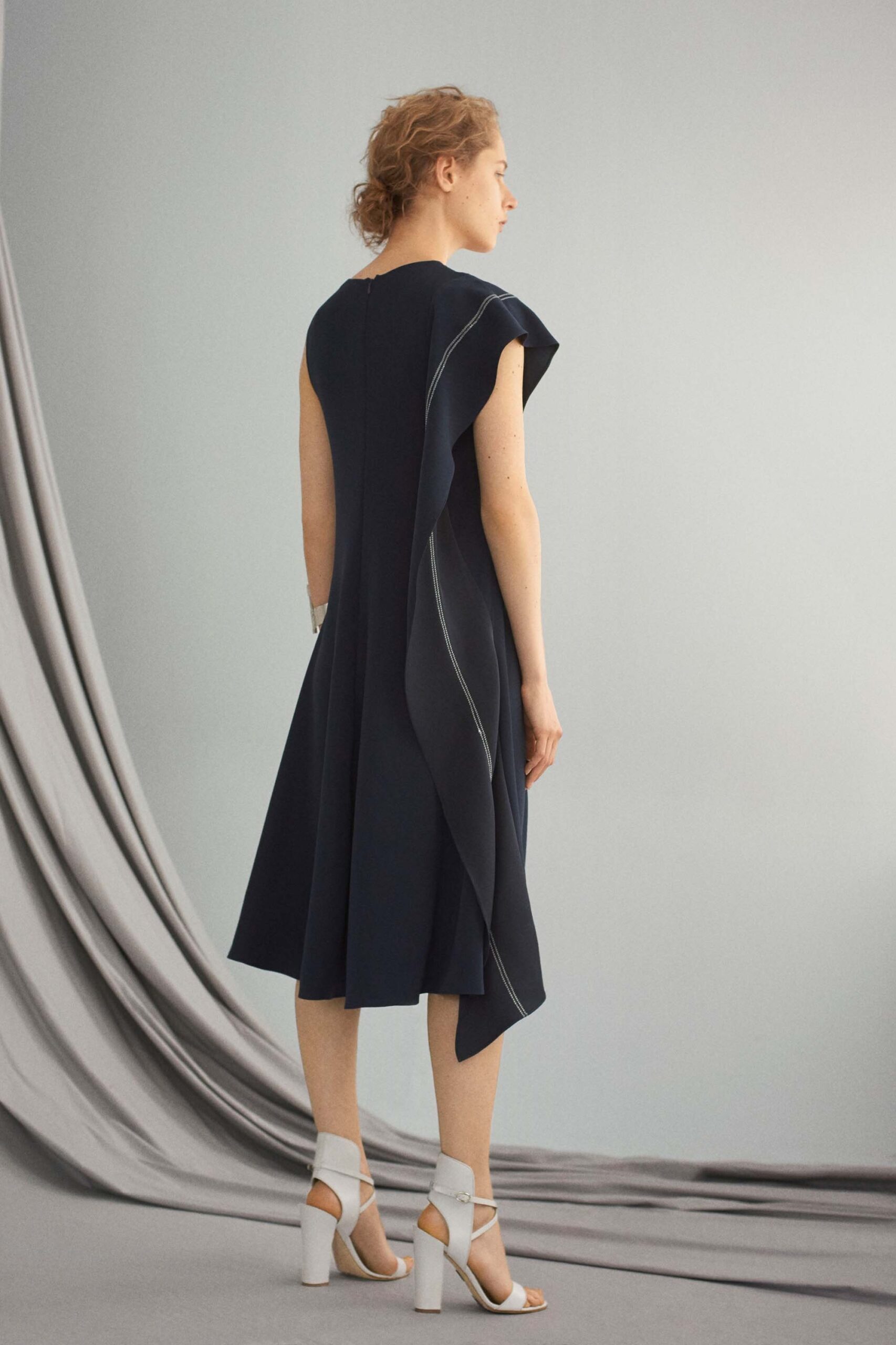 black silk draped midi dress with white shoes