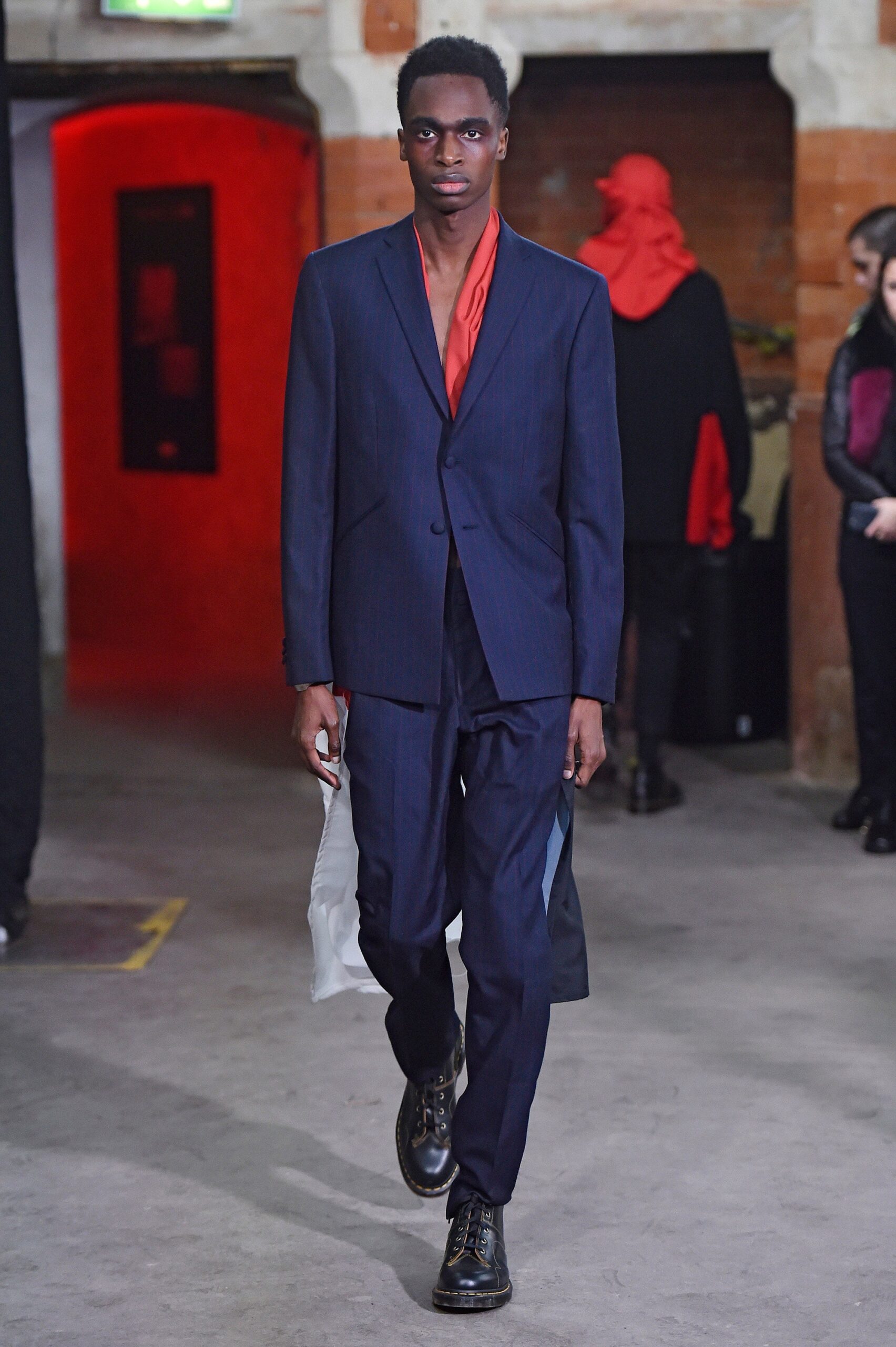 blue tailored suit with red shirt