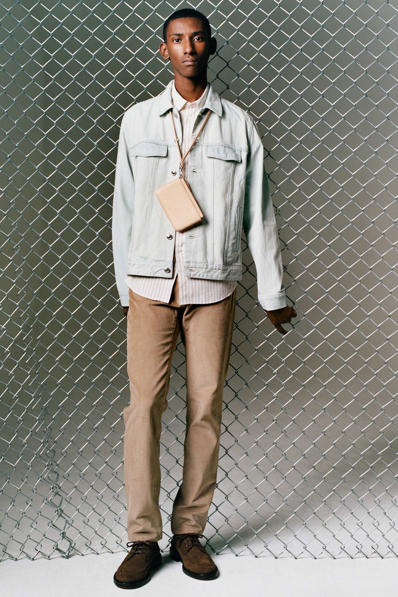 light blue denim jacket with beige pants
