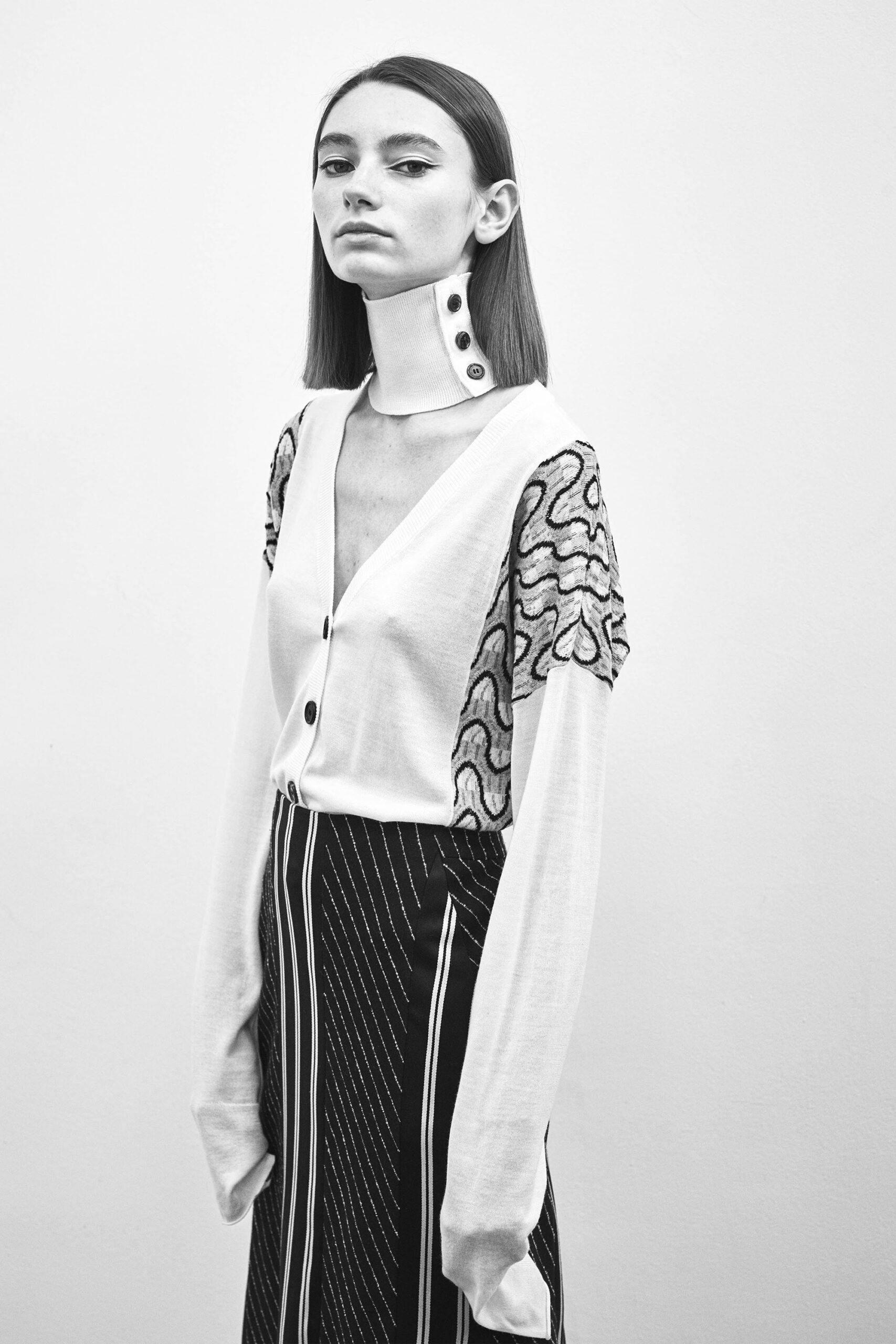 white embroidered blouse and black striped skirt