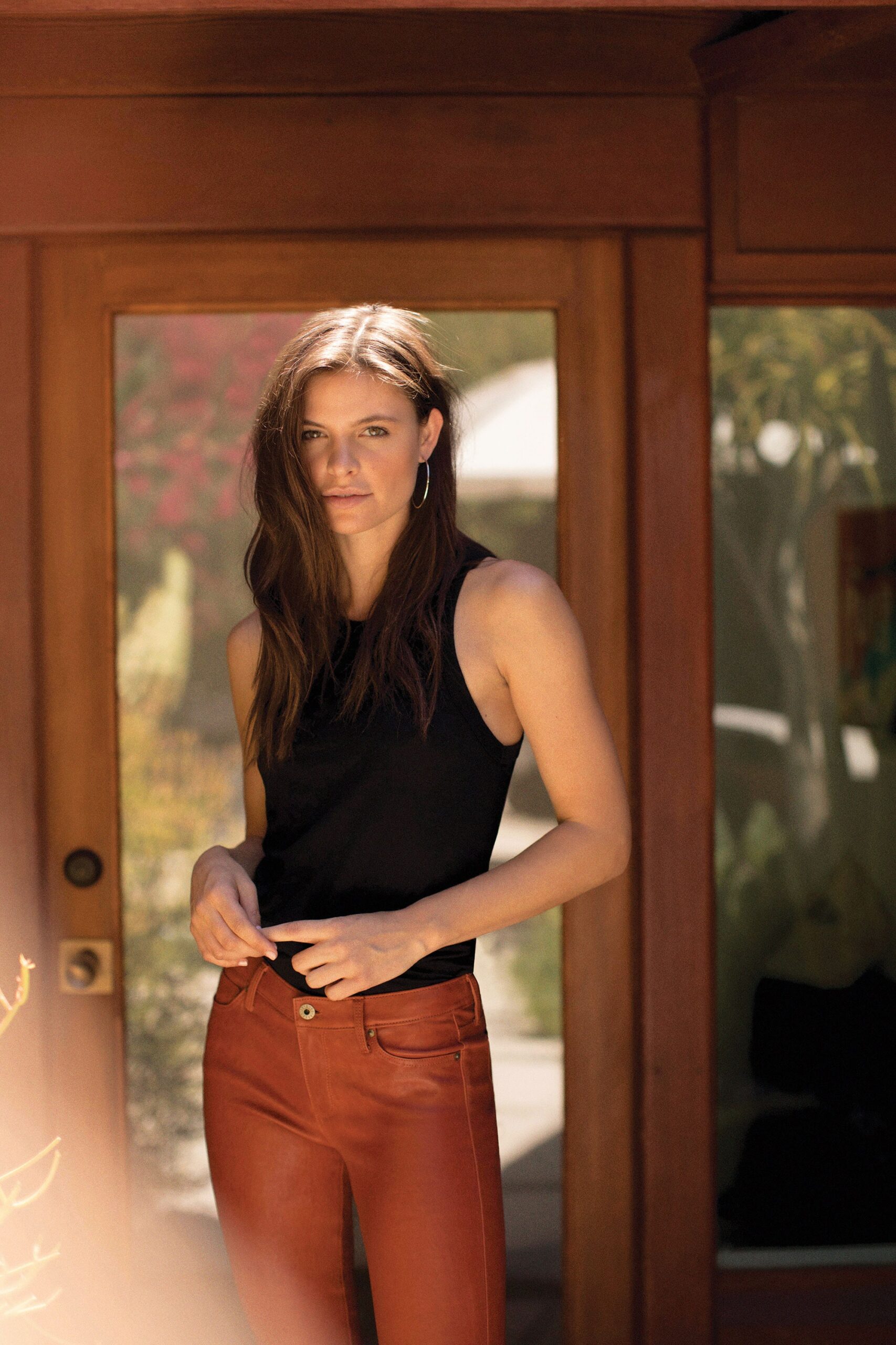 black fitted tank-top and brown leather pants