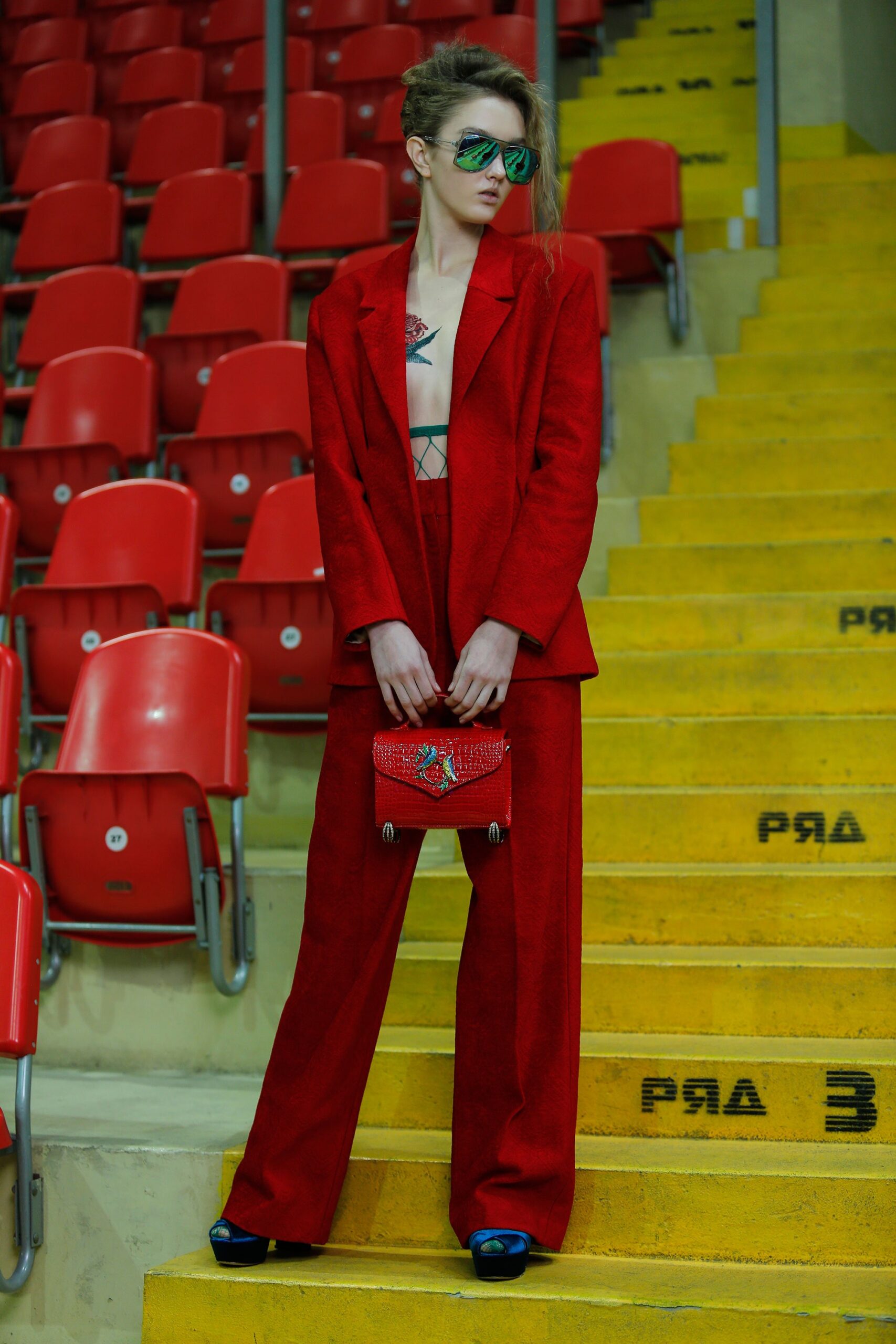 red tailored suit with black top