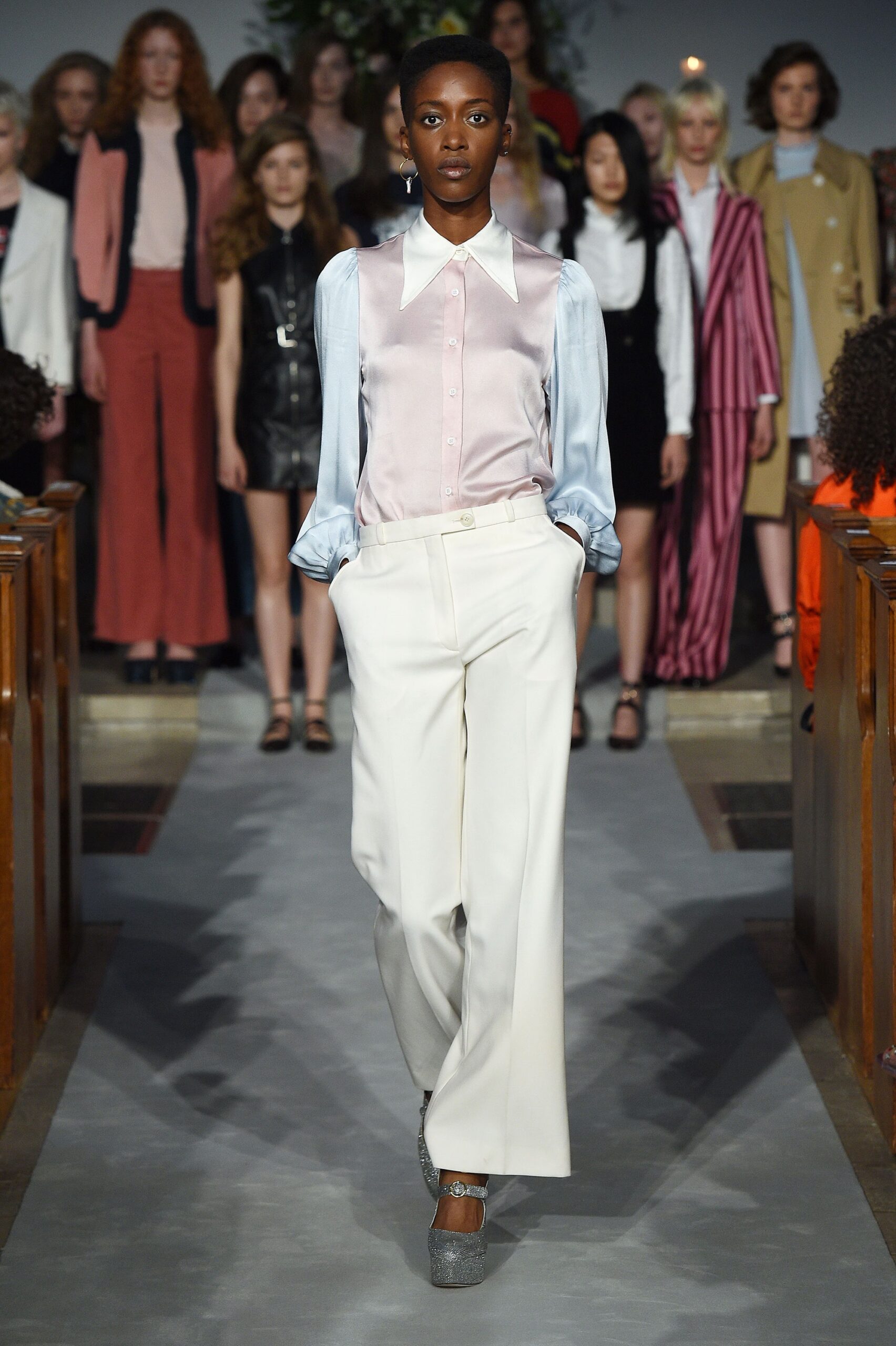 pink silk shirt and white pants