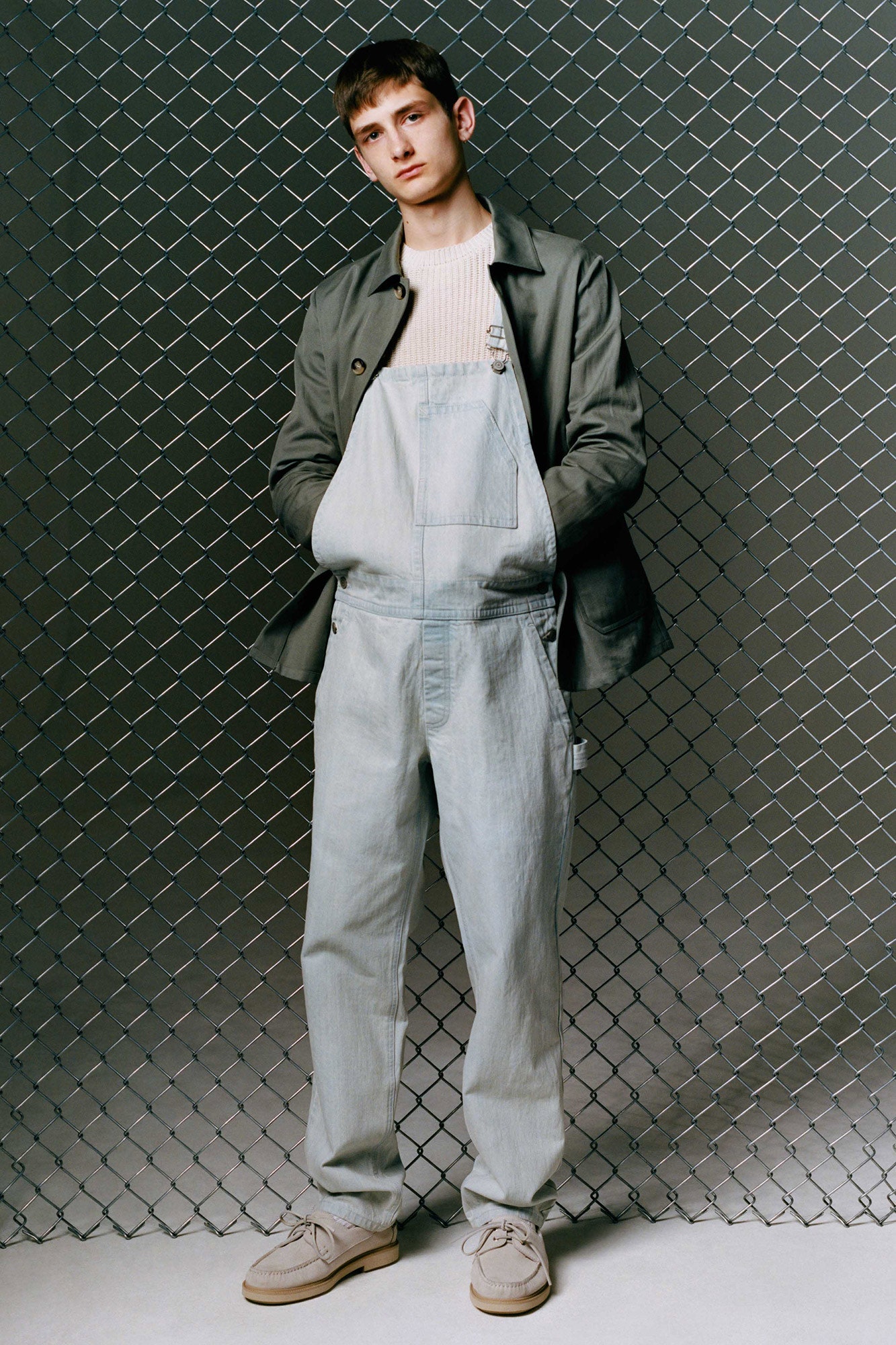 gray jacket light blue overalls beige sweater