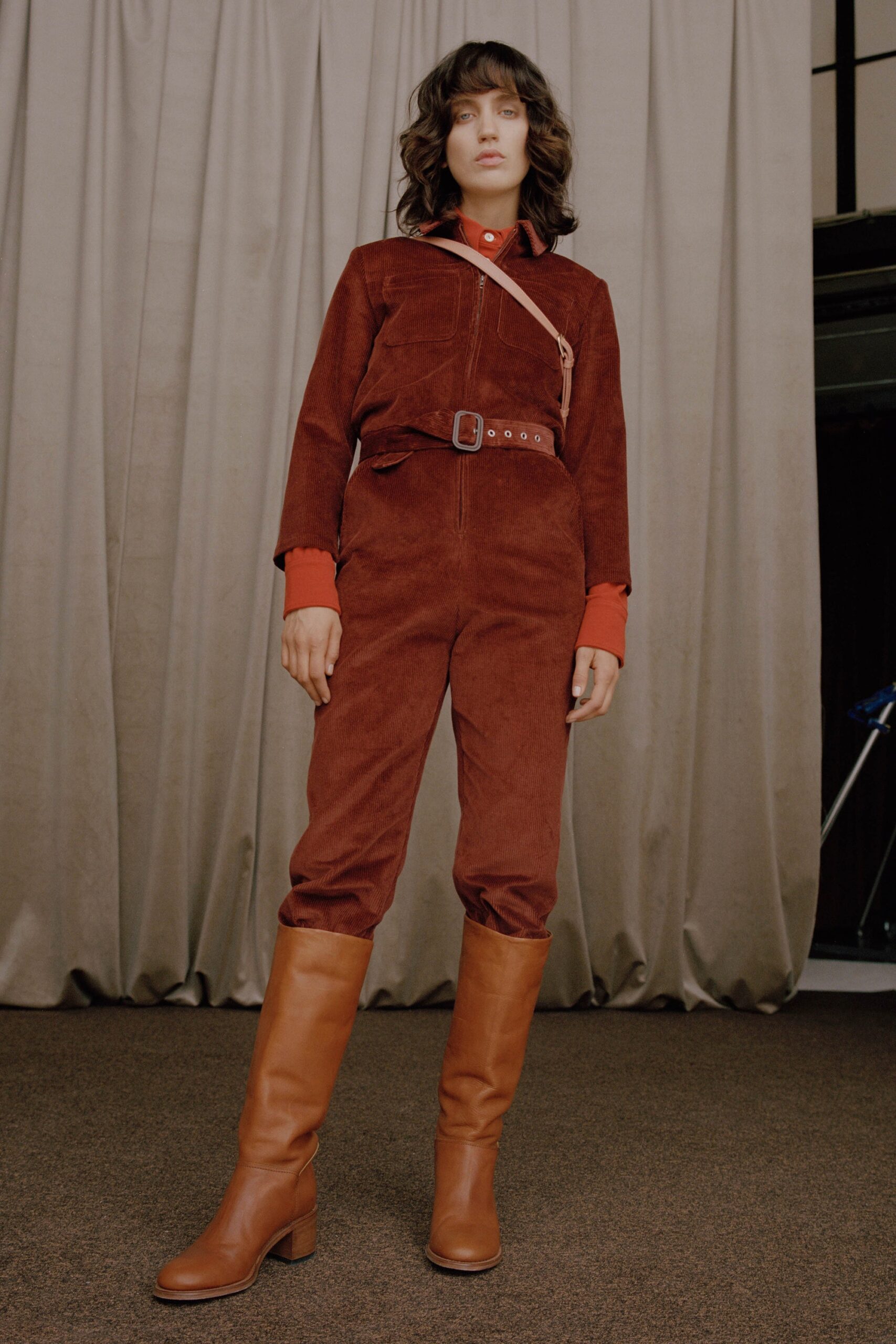 brown fitted jumpsuit with boots