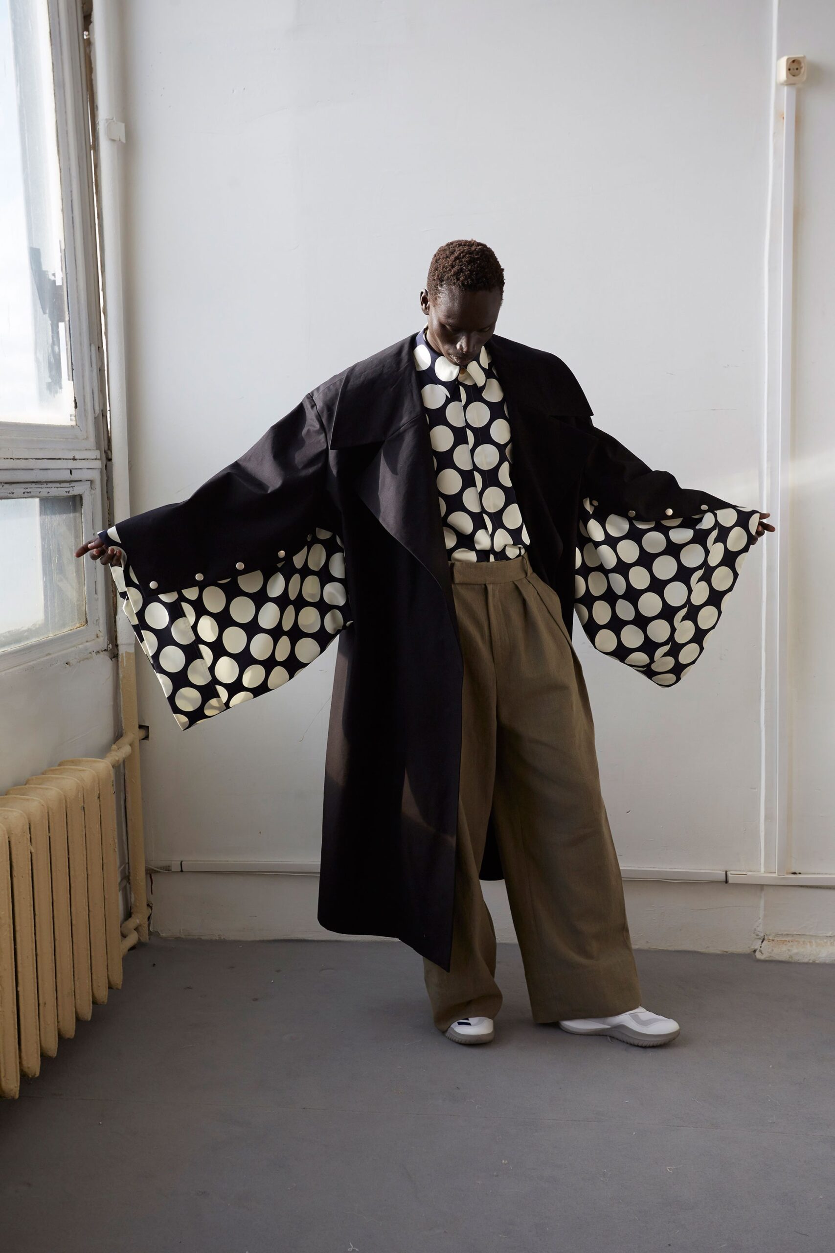 black coat with polka-dot shirt