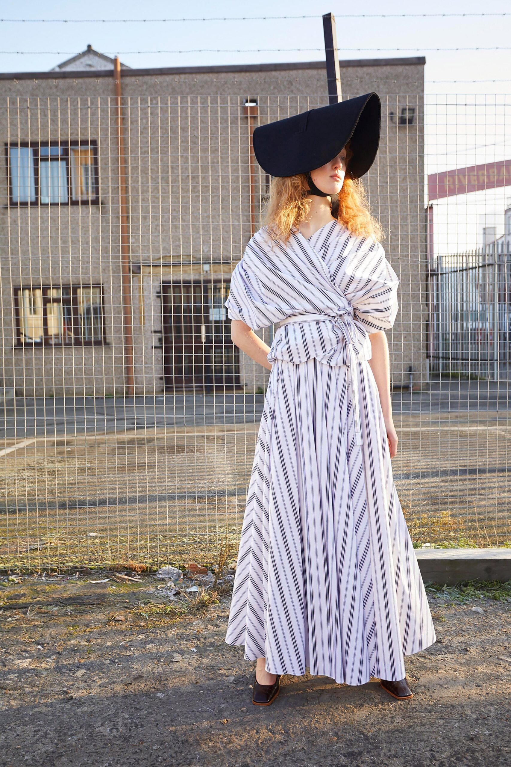 striped maxi dress with wide-brimmed hat