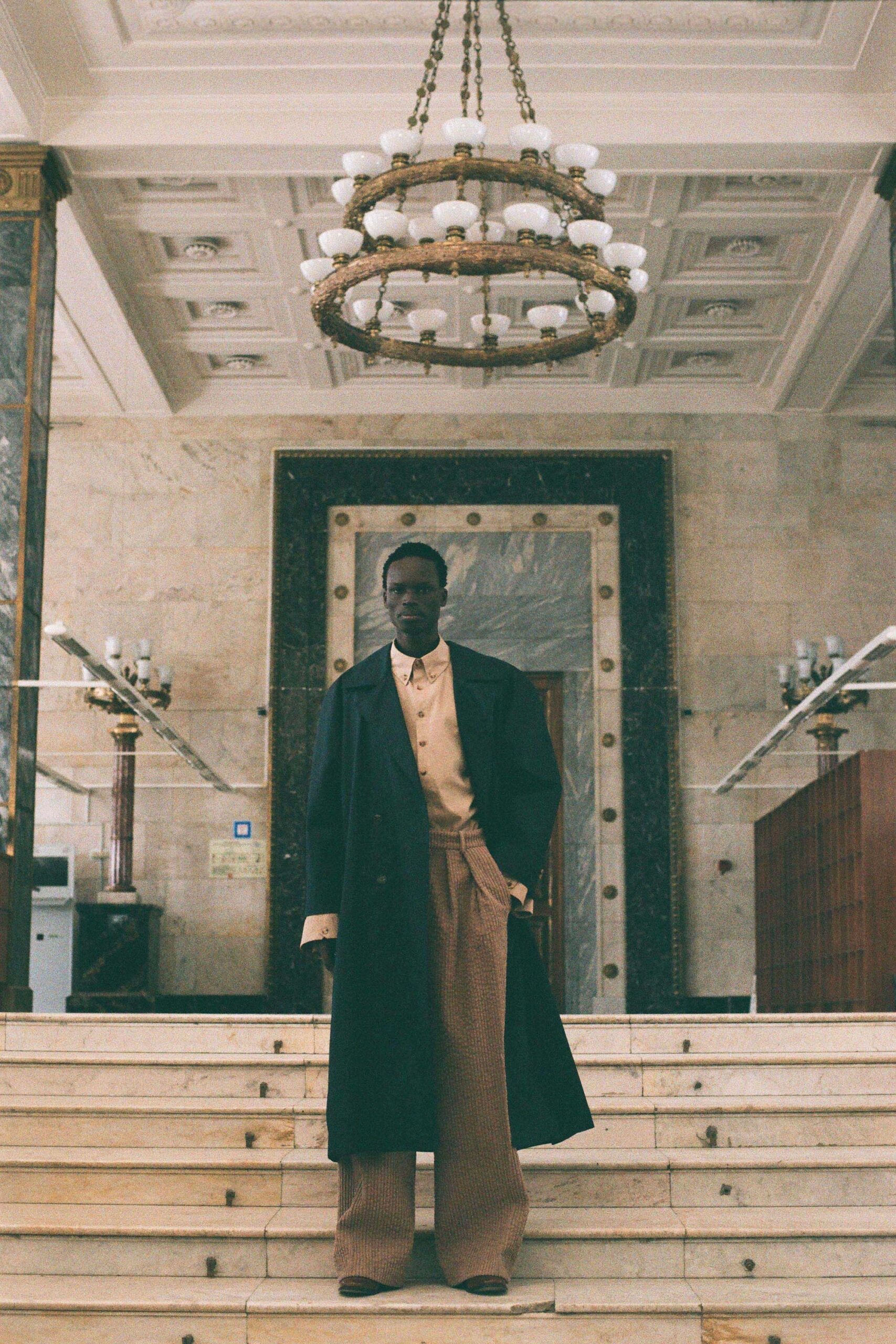 black wool coat beige shirt brown pants