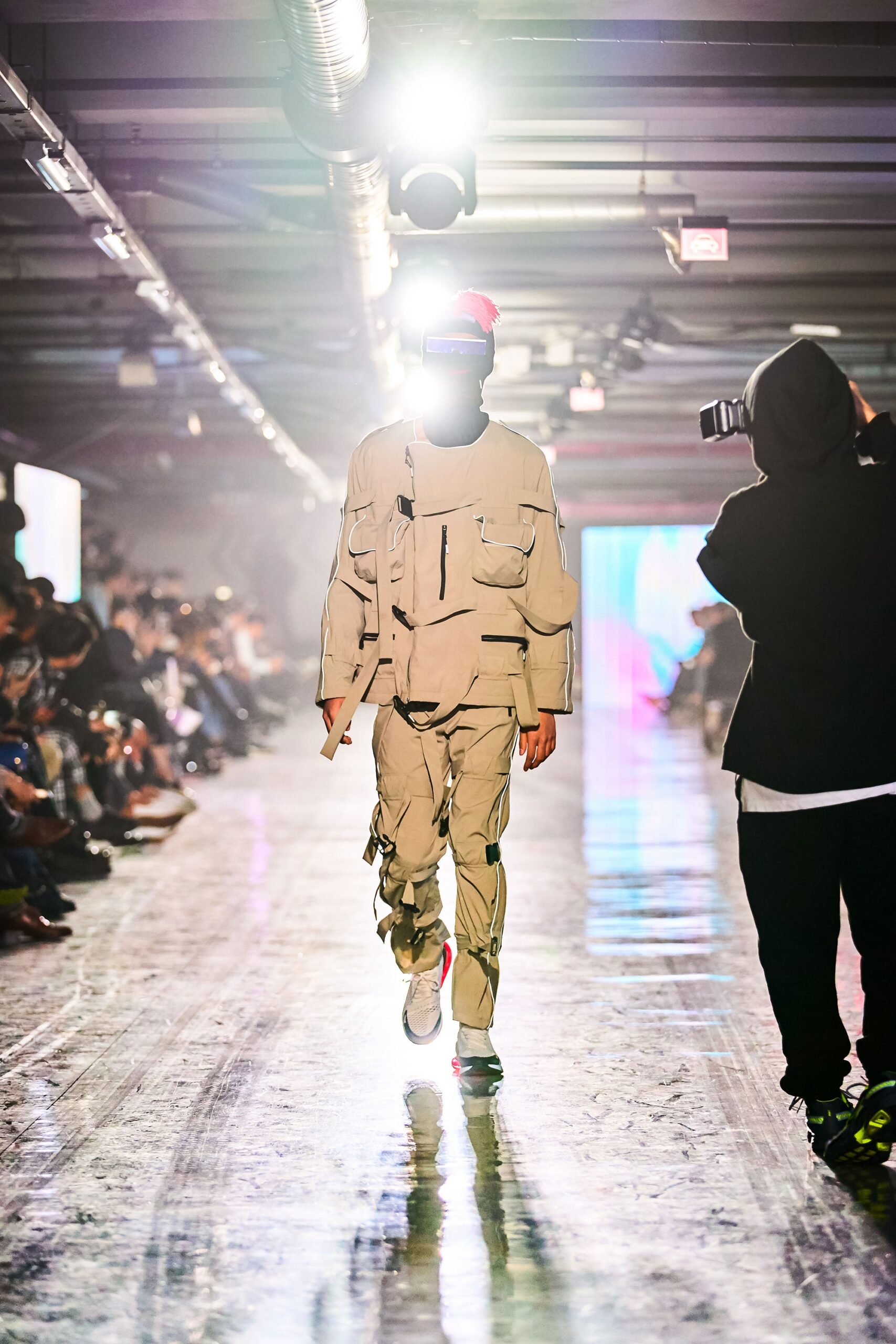 A relaxed beige cotton jacket with long sleeves and matching pants featuring zippered details.