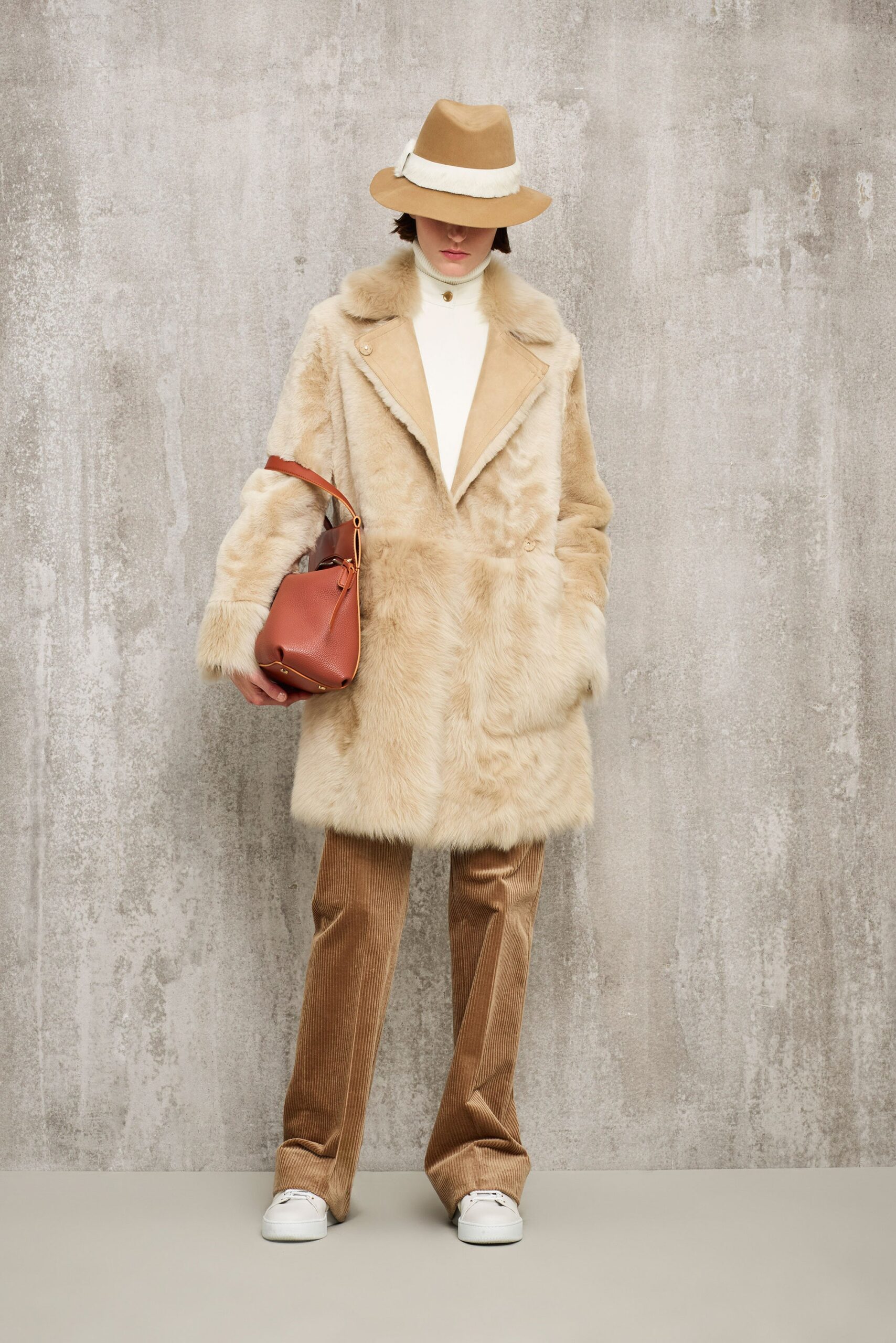 beige faux-fur coat with brown pants