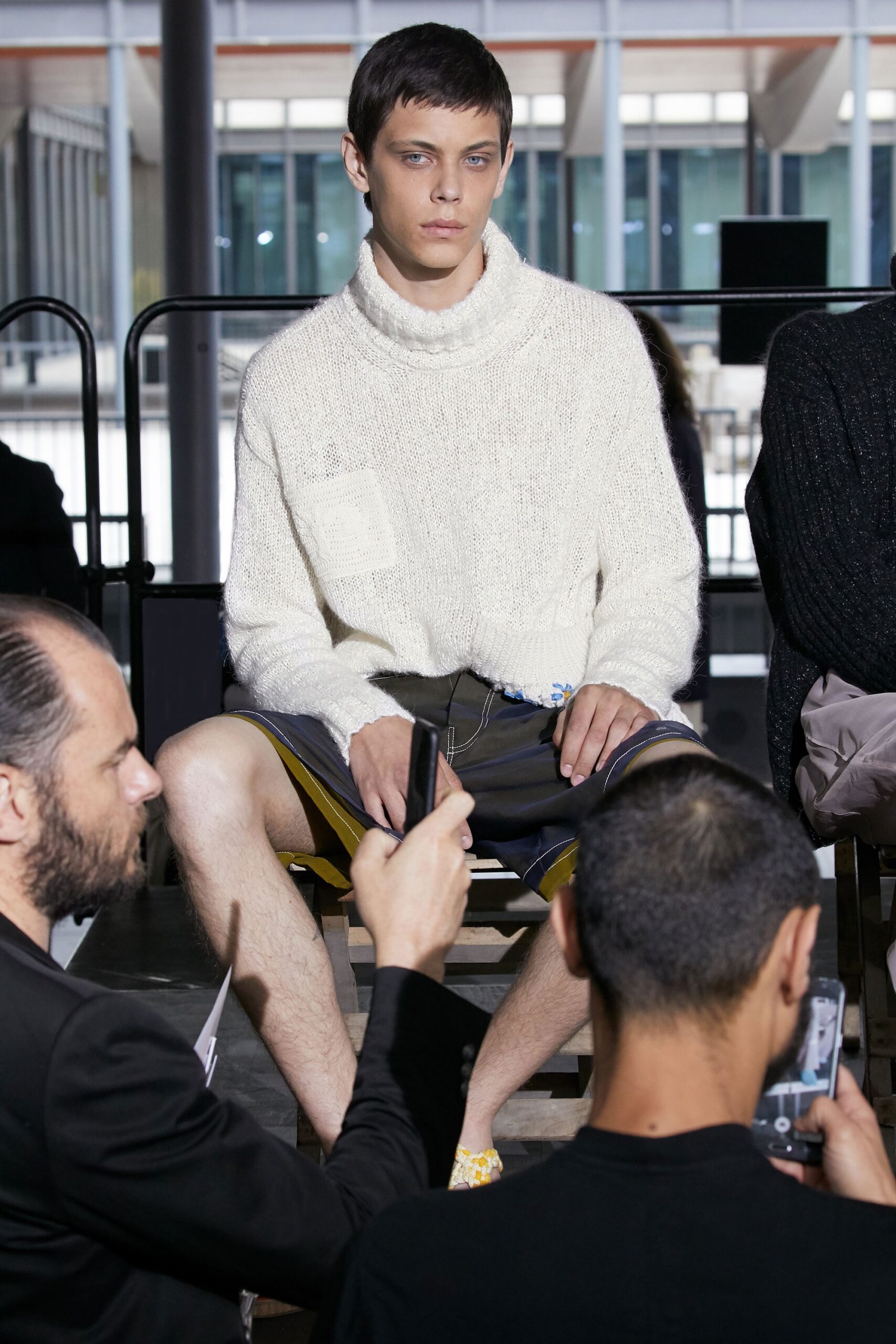 white relaxed sweater and black shorts