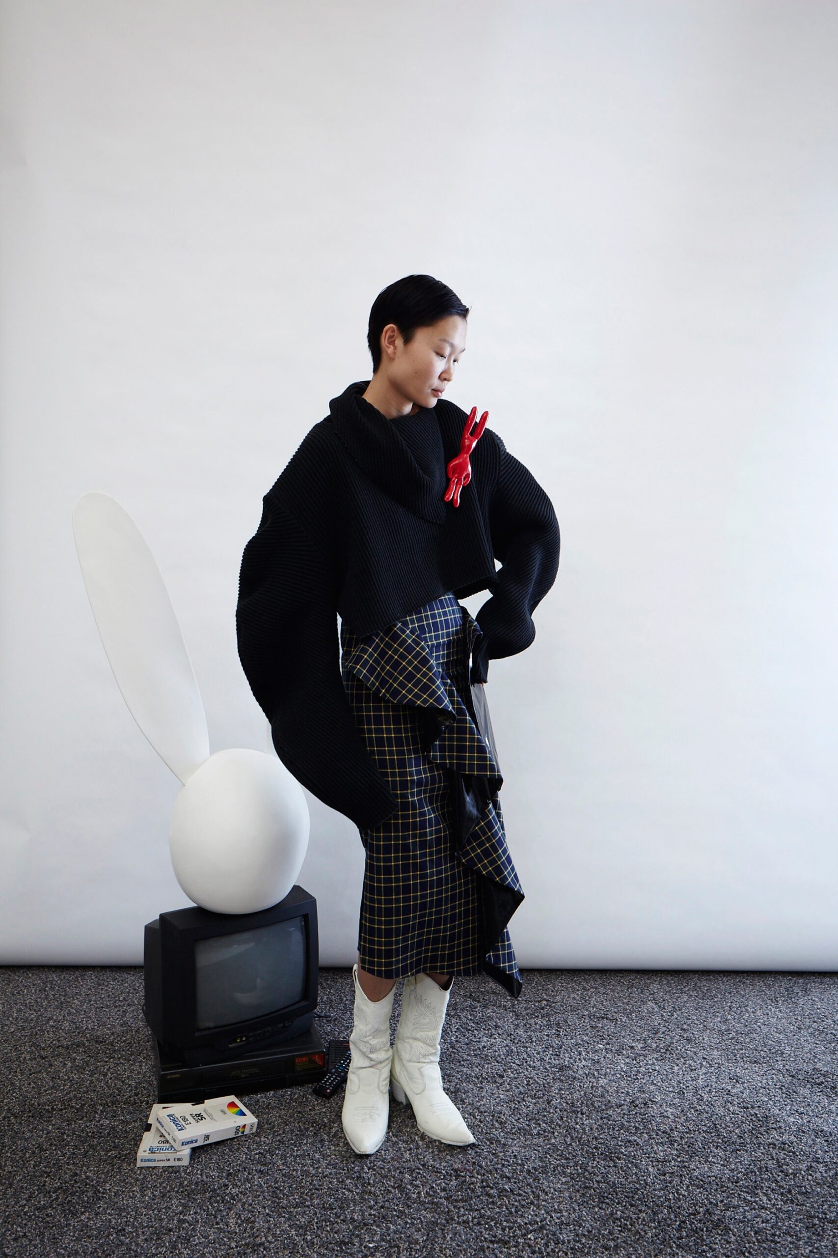 oversized black knit top with pleated midi skirt