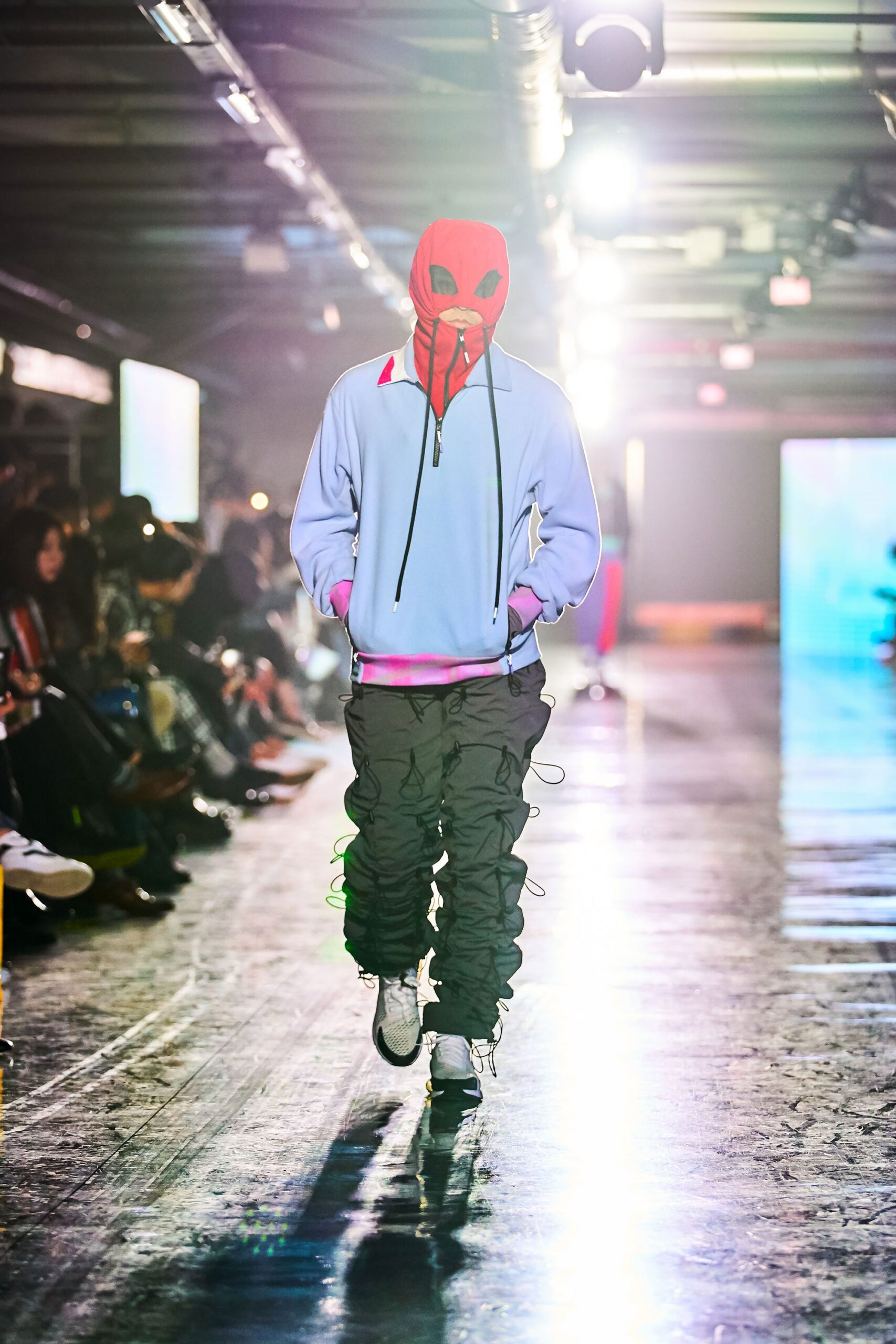 A relaxed blue hoodie with a hood and long sleeves paired with black relaxed-fit pants.