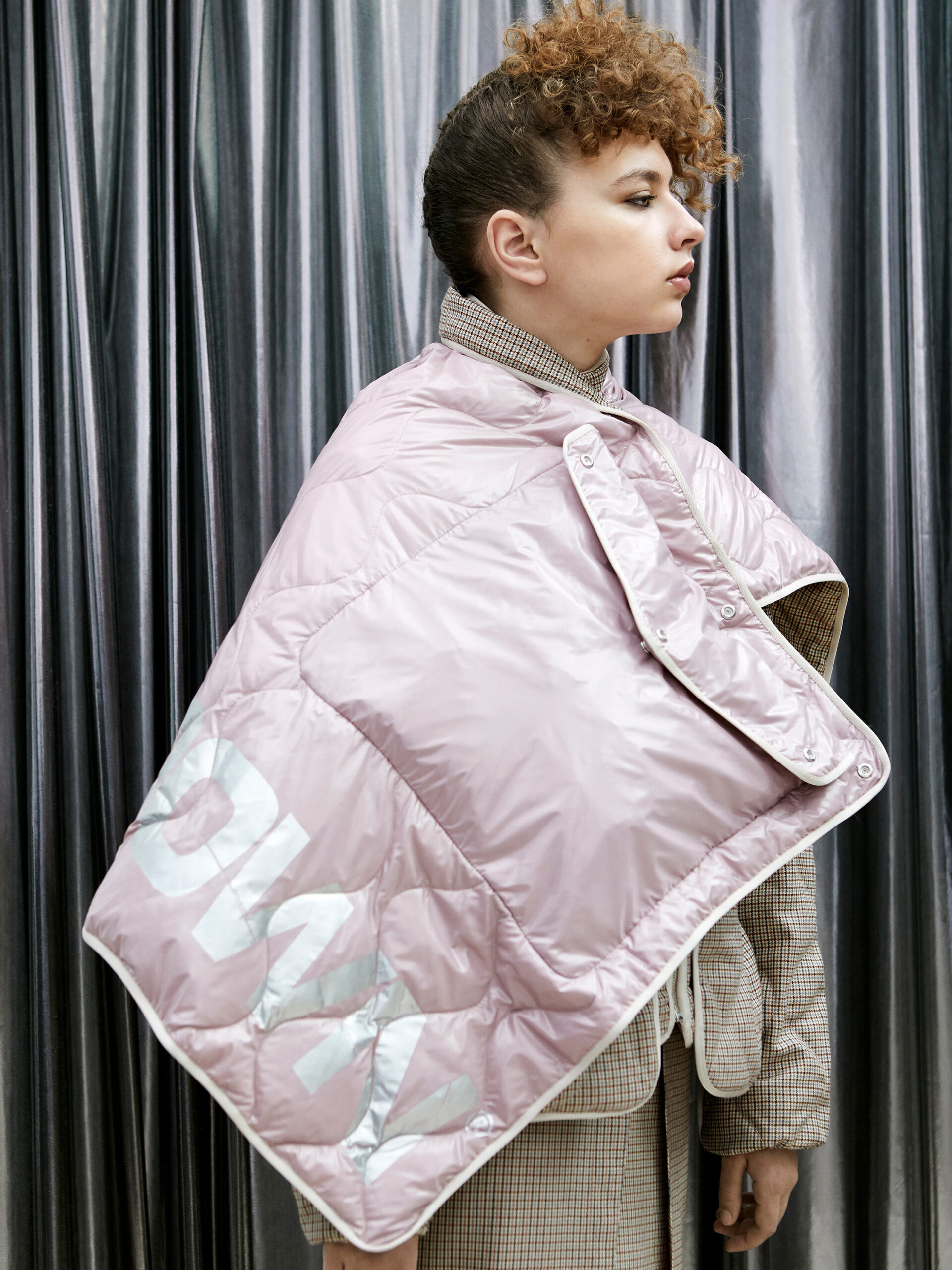 pink vinyl cape with beige blazer