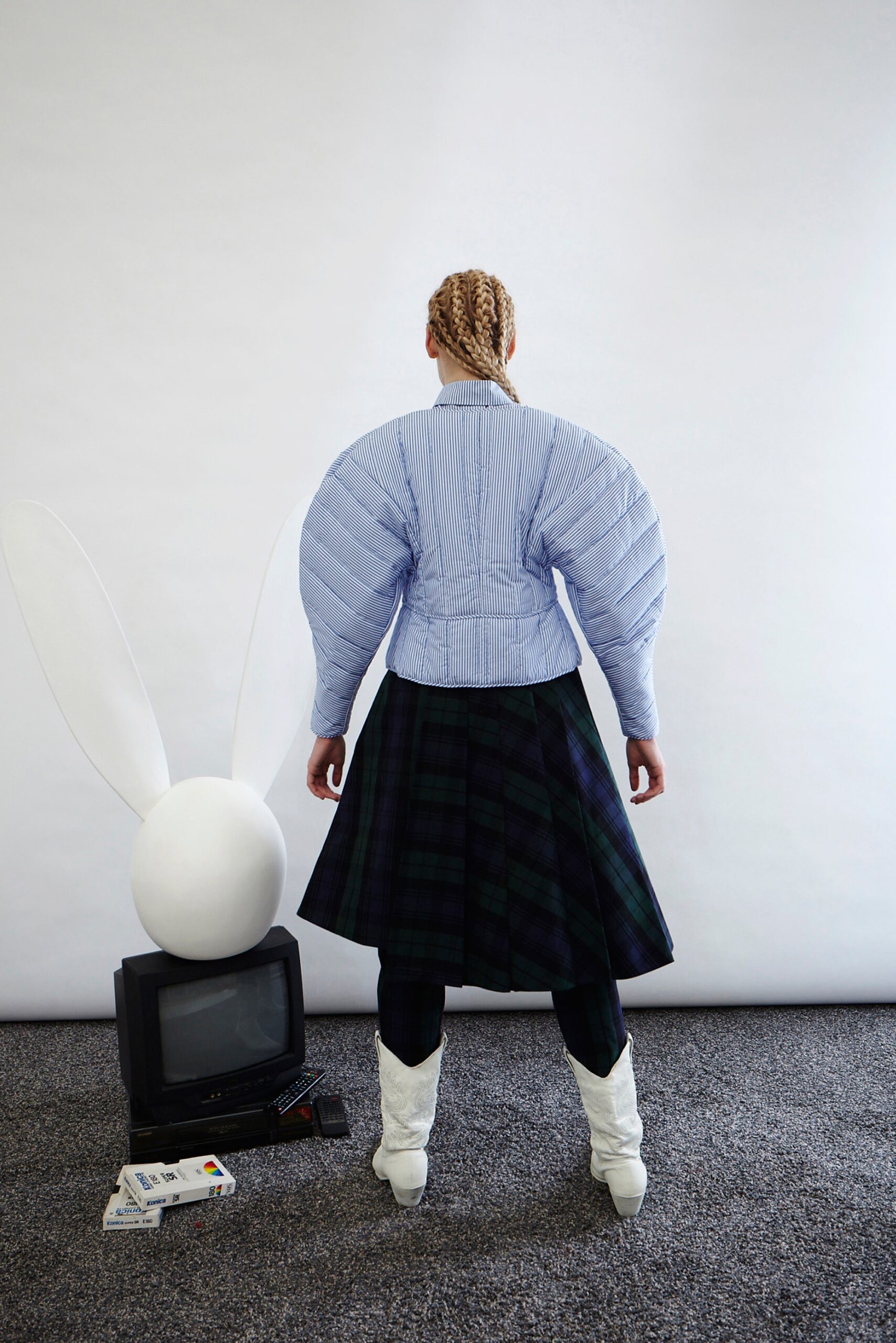blue padded jacket and pleated skirt