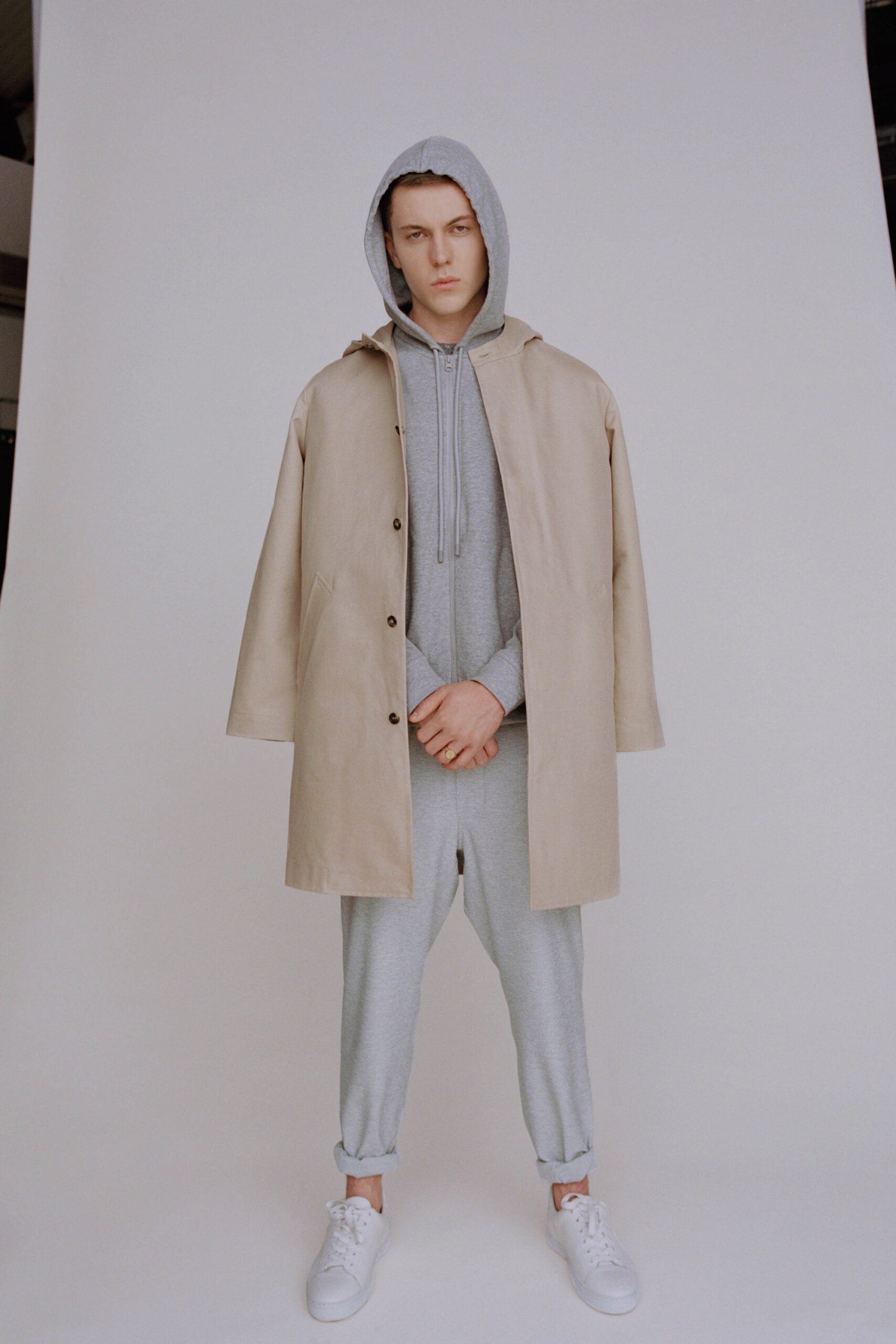 beige coat gray hoodie pants