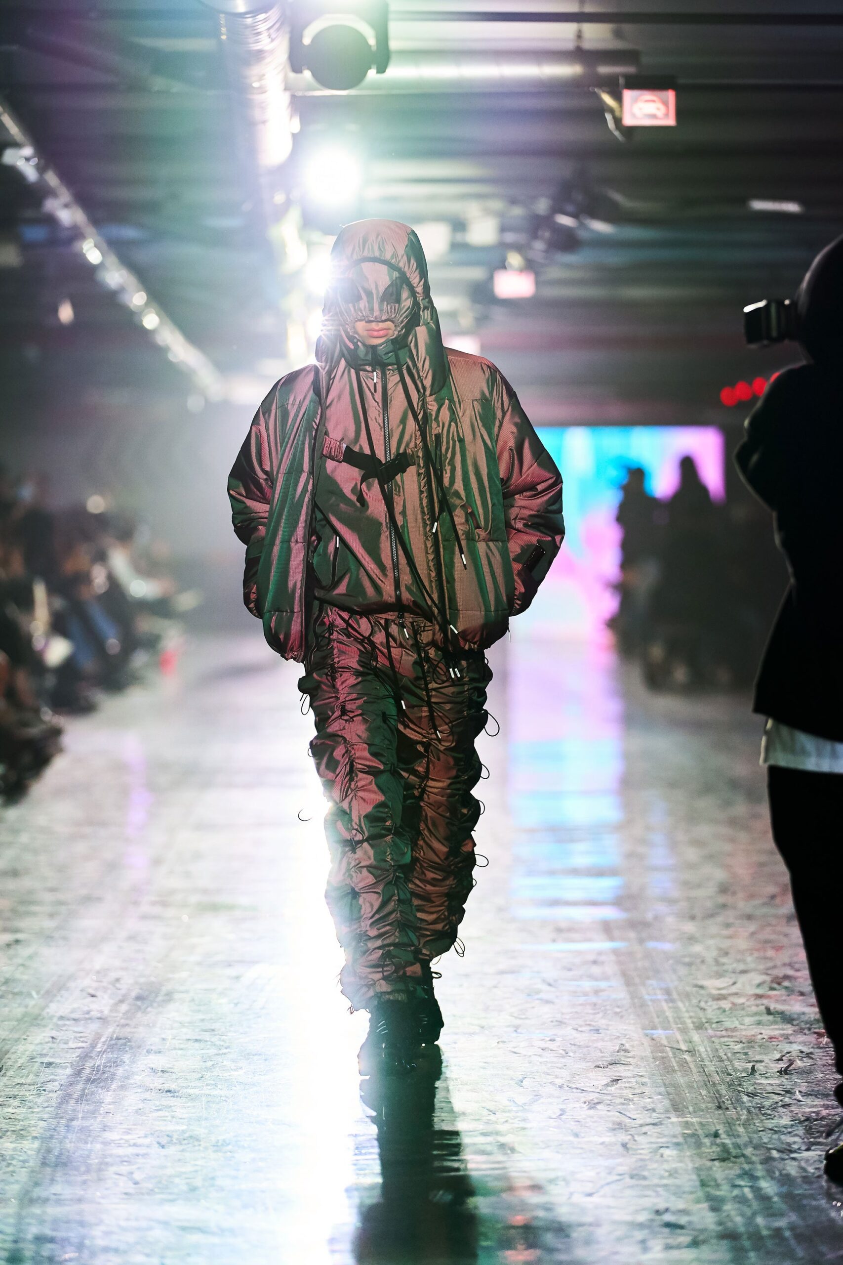 A relaxed black and green jacket with a hood and layered design, paired with matching pants.
