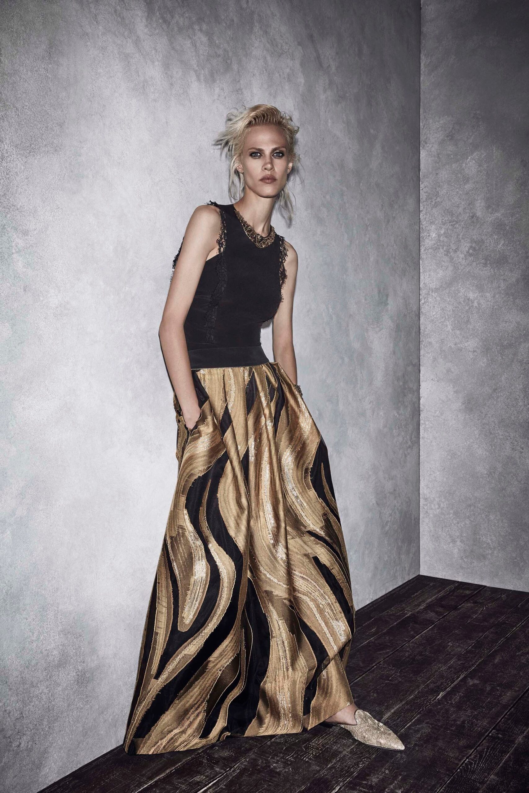 black fitted top with gold pleated skirt