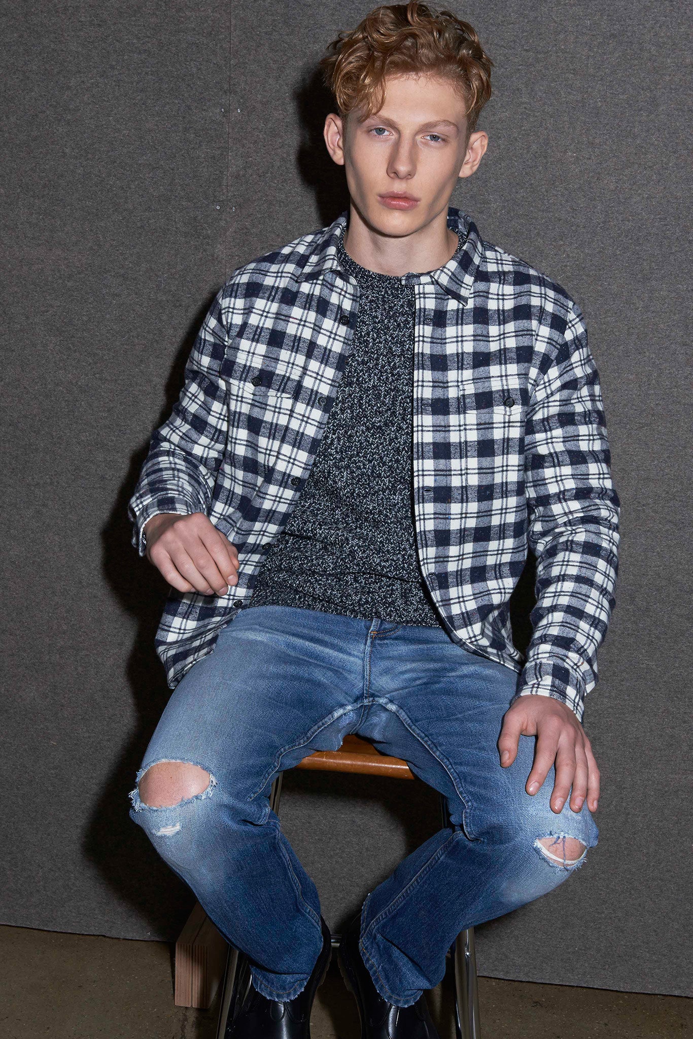 checked shirt gray sweater blue jeans