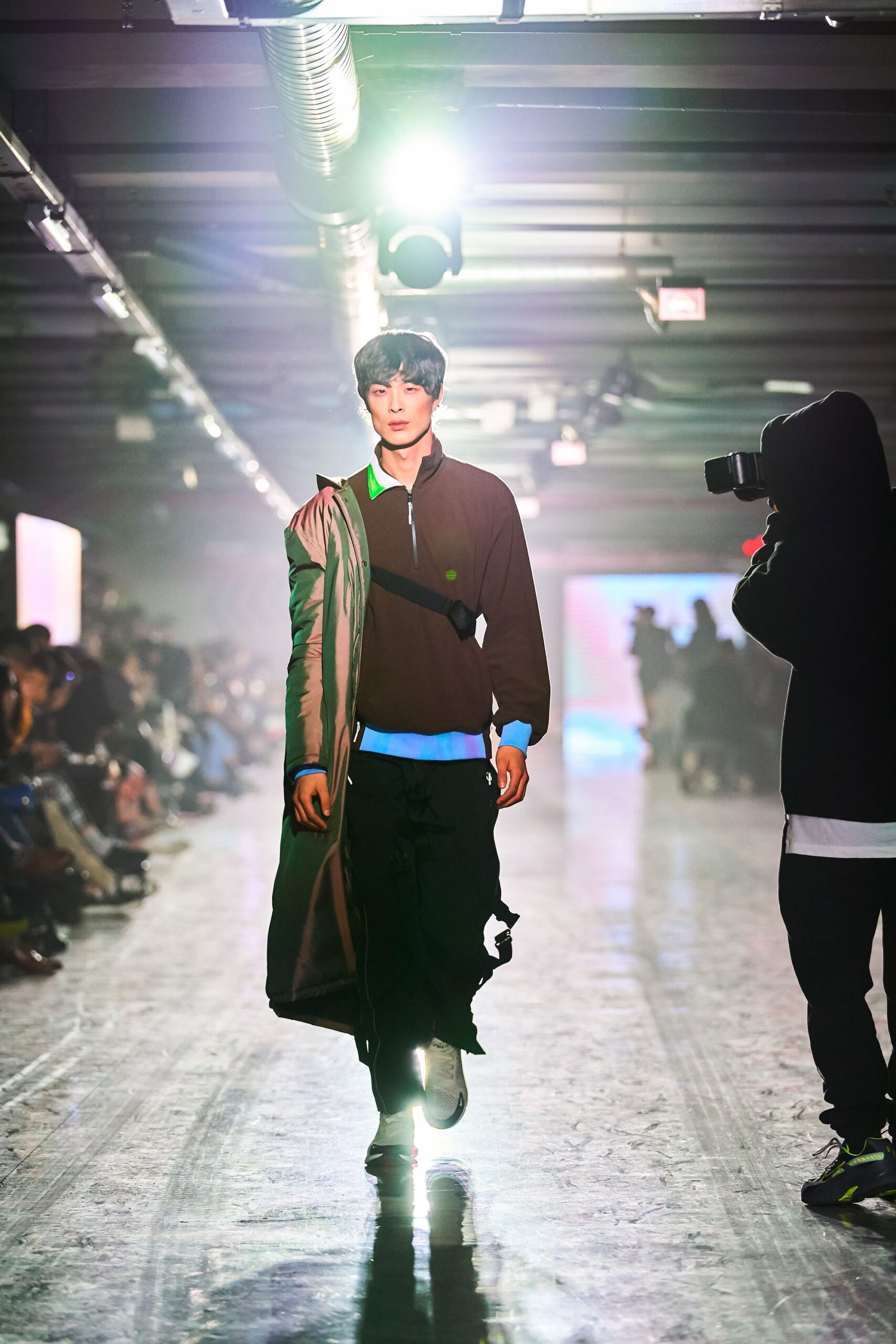 A relaxed brown jacket with long sleeves and a collared design, paired with black pants.