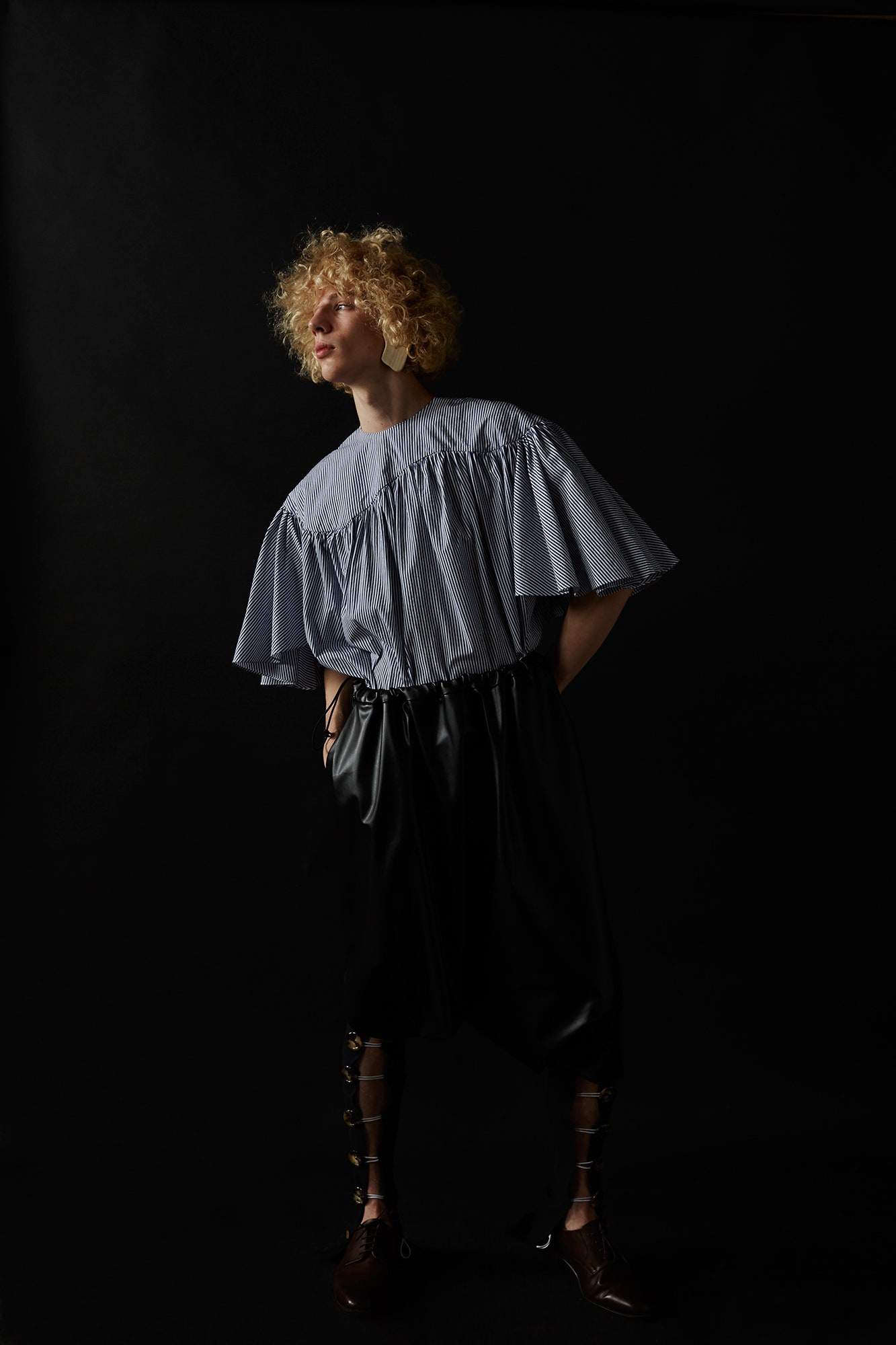 blue and white pleated top with black leather pants