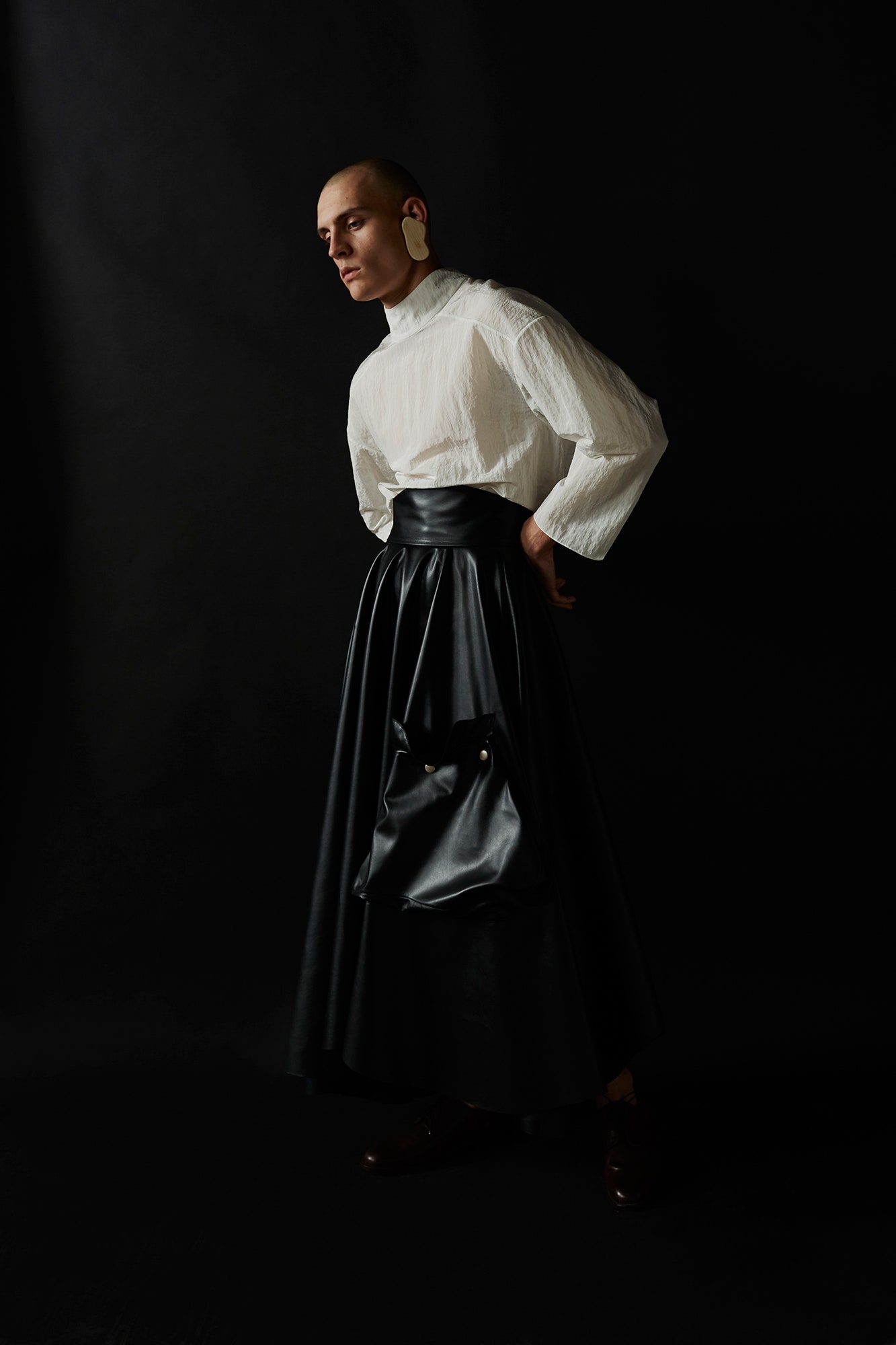 white relaxed blouse and black leather skirt