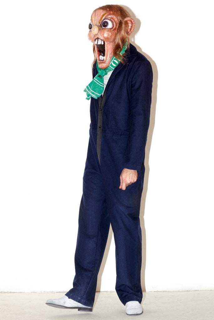 blue fitted jumpsuit with green scarf