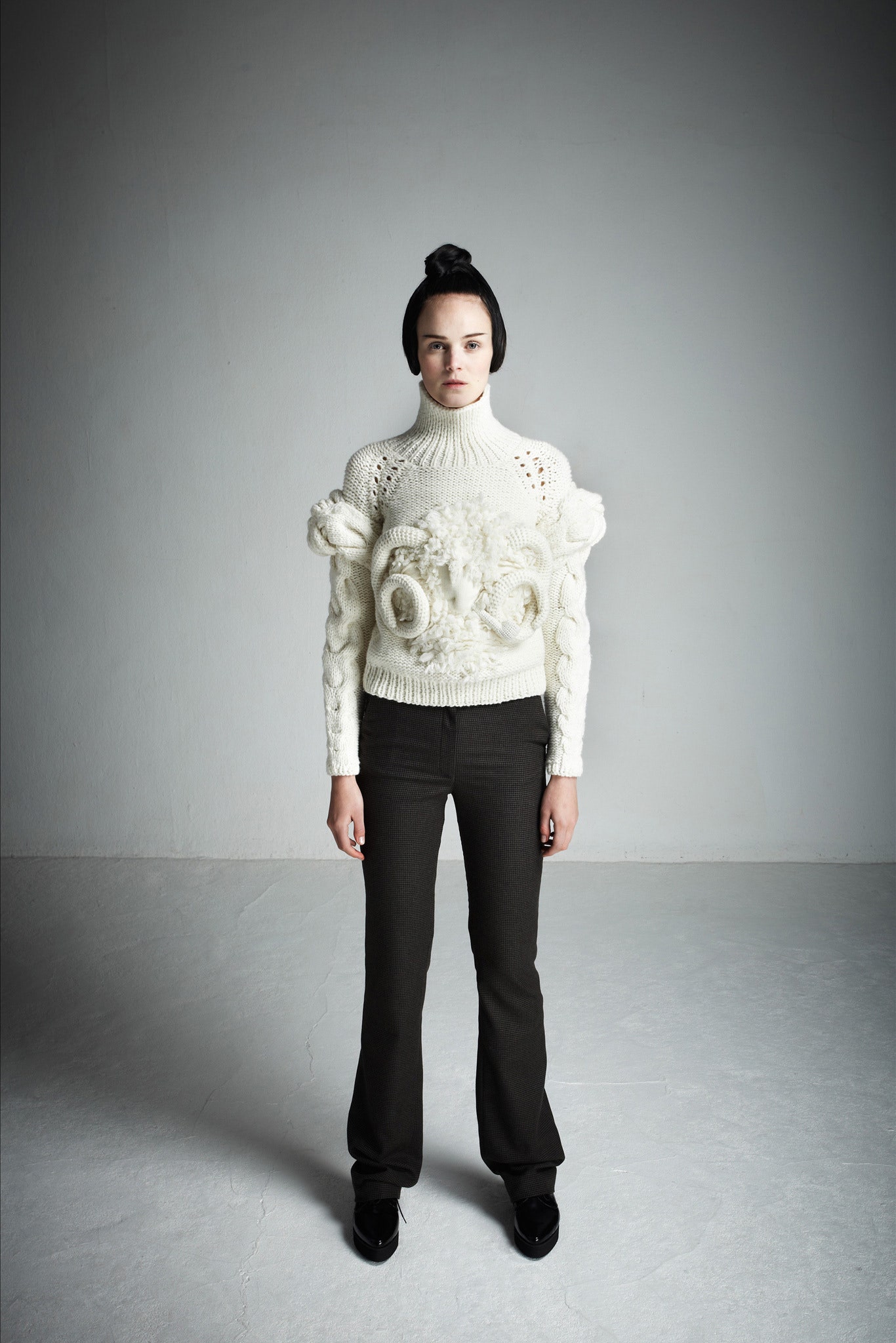 white embellished fitted sweater and black tailored pants
