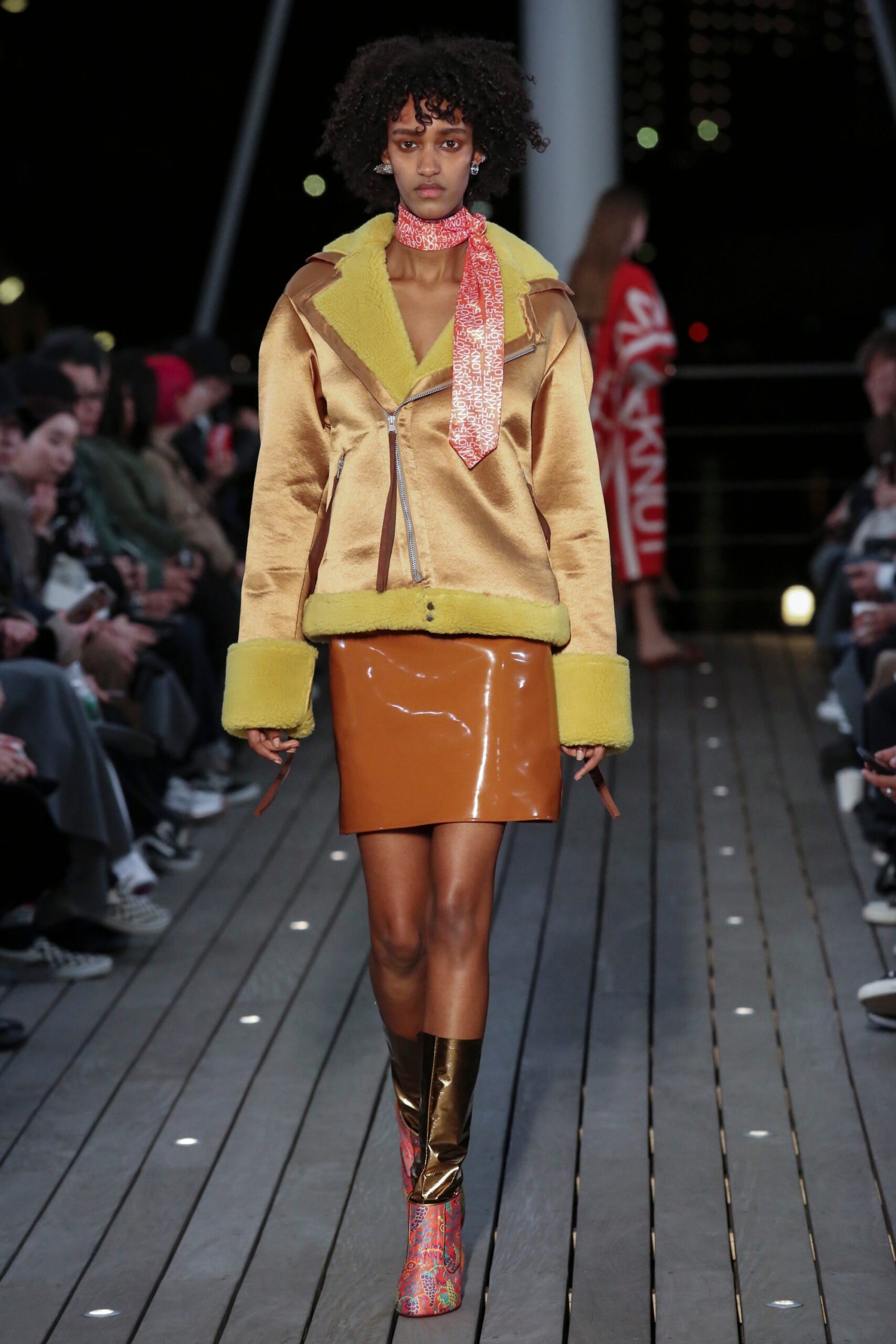 A fitted yellow leather collared jacket paired with a brown pencil skirt.