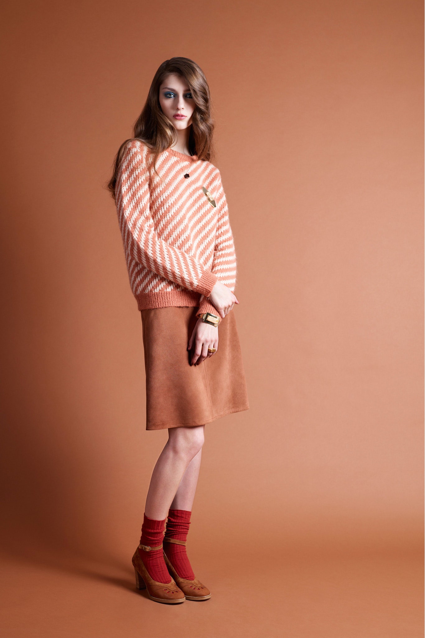 orange striped sweater with brown skirt