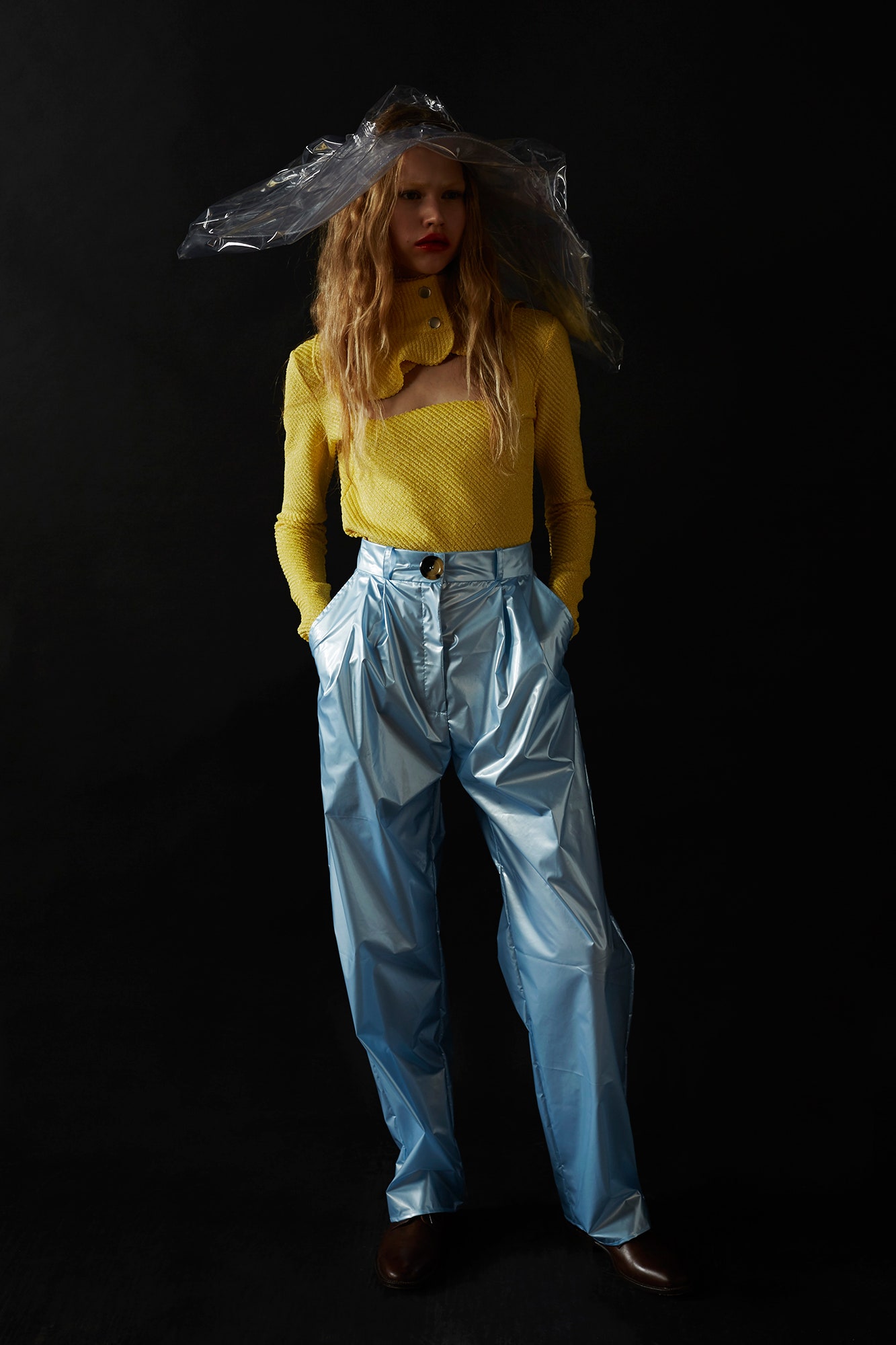 yellow fitted top and blue vinyl pants