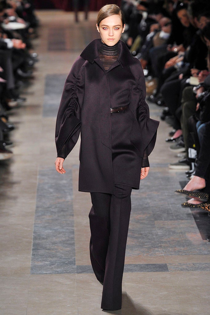 black fitted coat and tailored pants