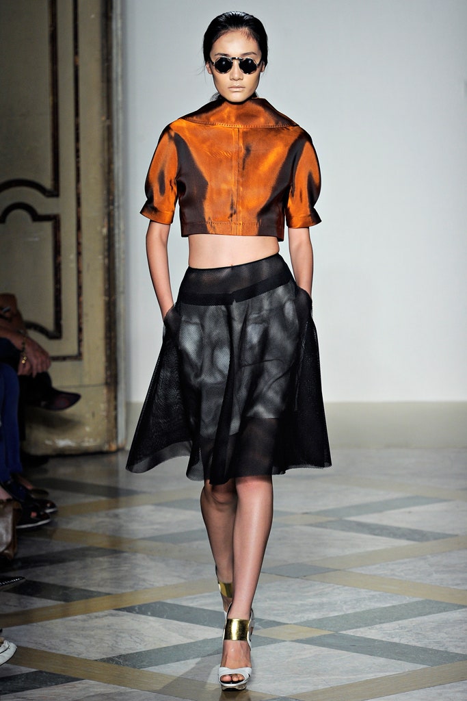 orange silk cropped top with black pleated skirt