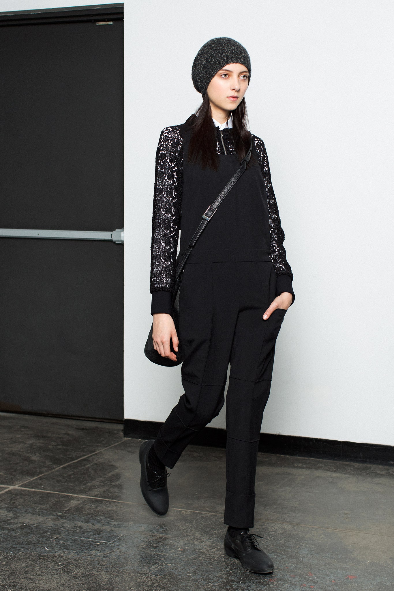 black fitted jumpsuit with gray knit hat