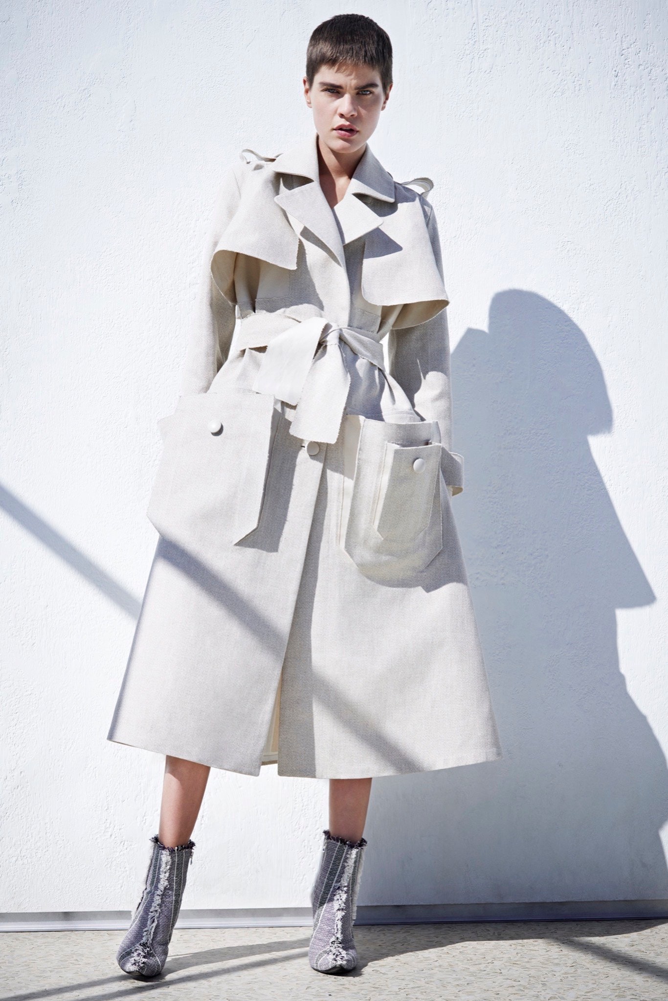 beige cotton trench coat with gray boots