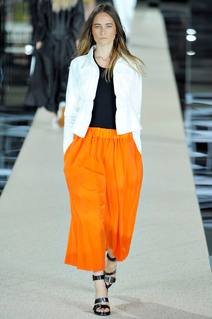 white jacket black top orange skirt