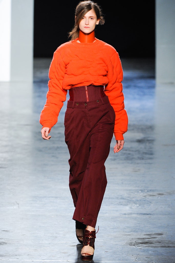 orange fitted sweater and maroon pants