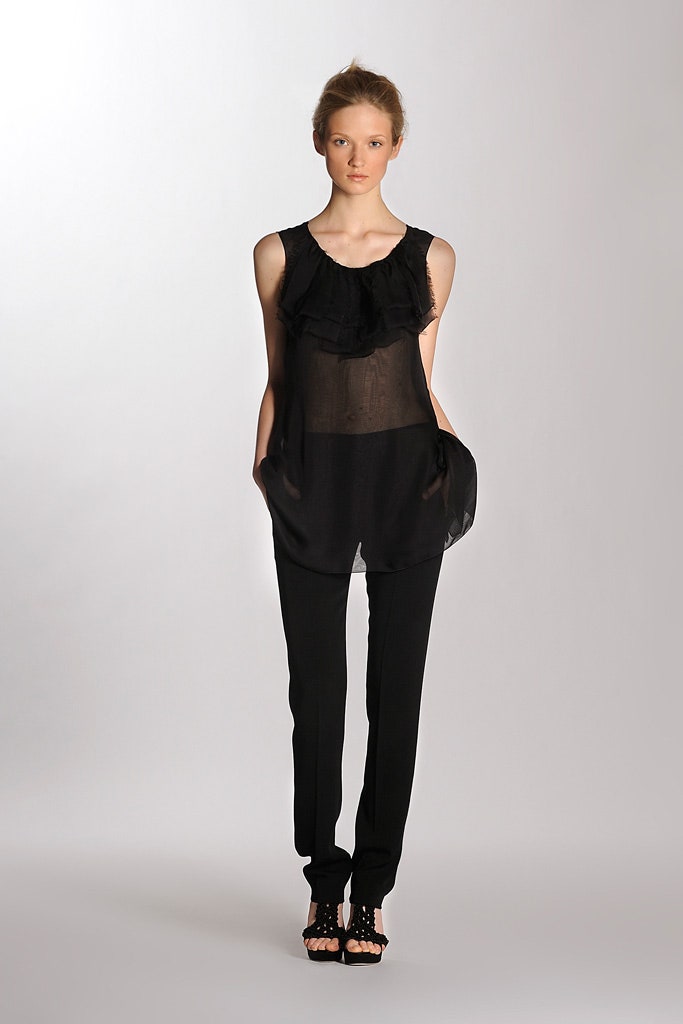 black sheer ruffled top and fitted pants