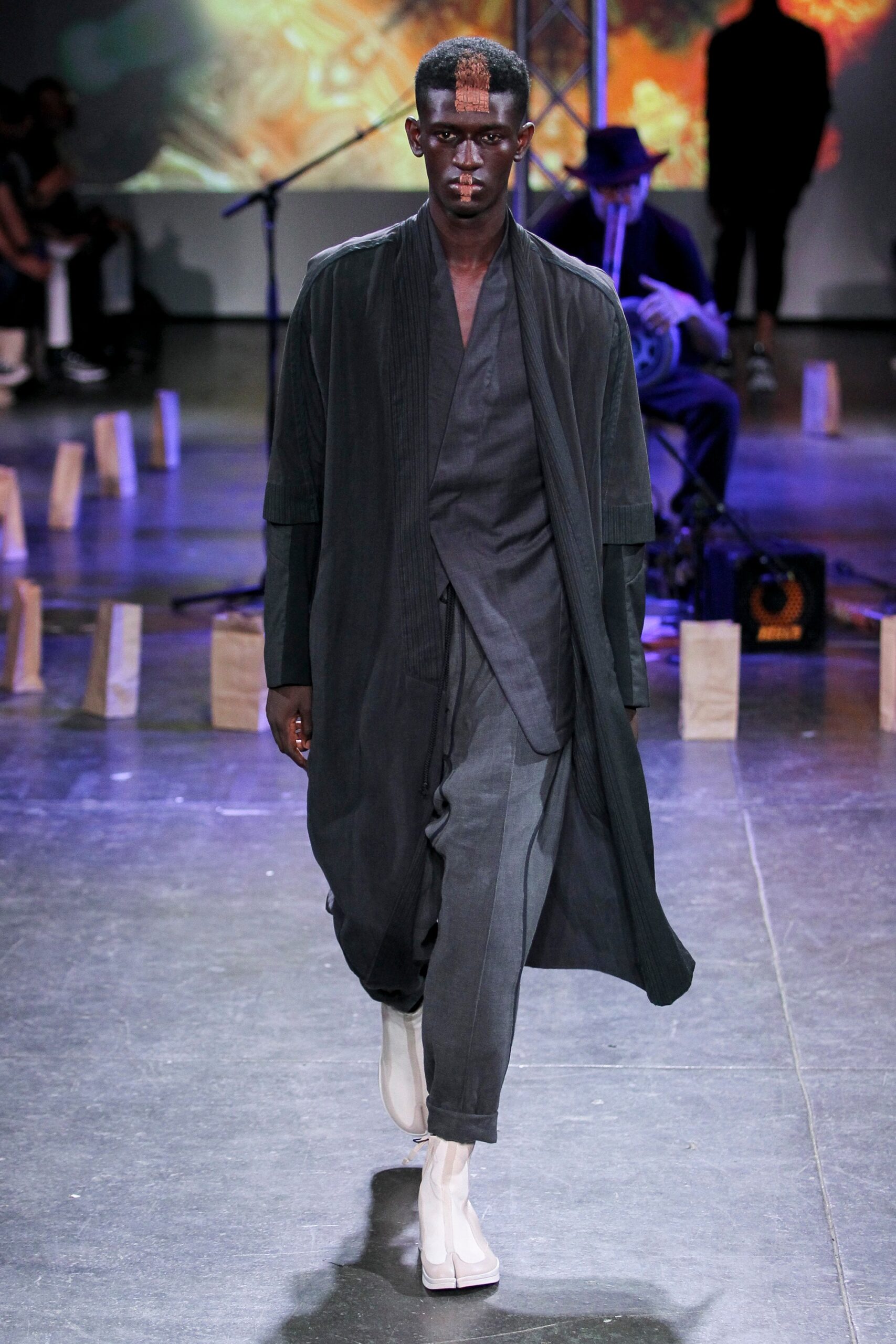 black coat gray pants white shoes