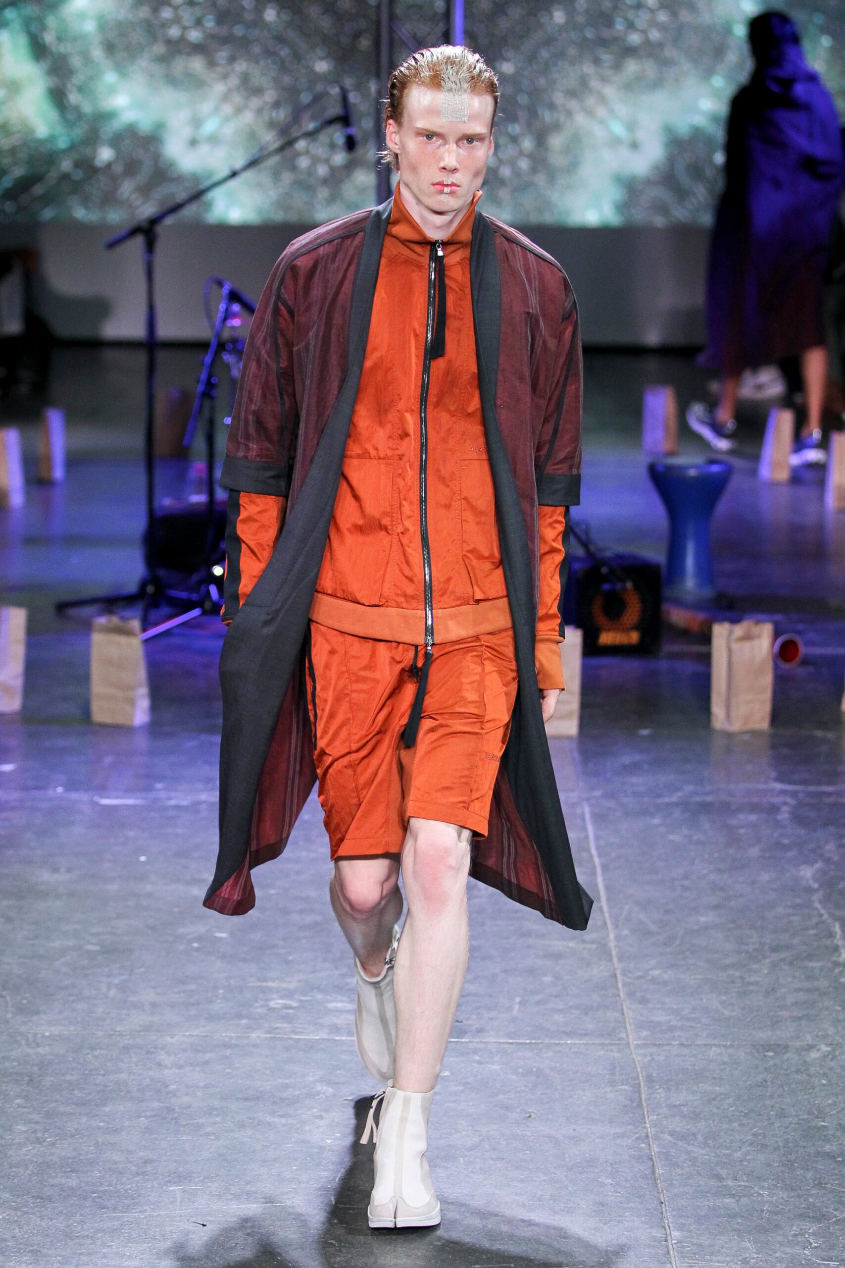 black jacket orange top shorts