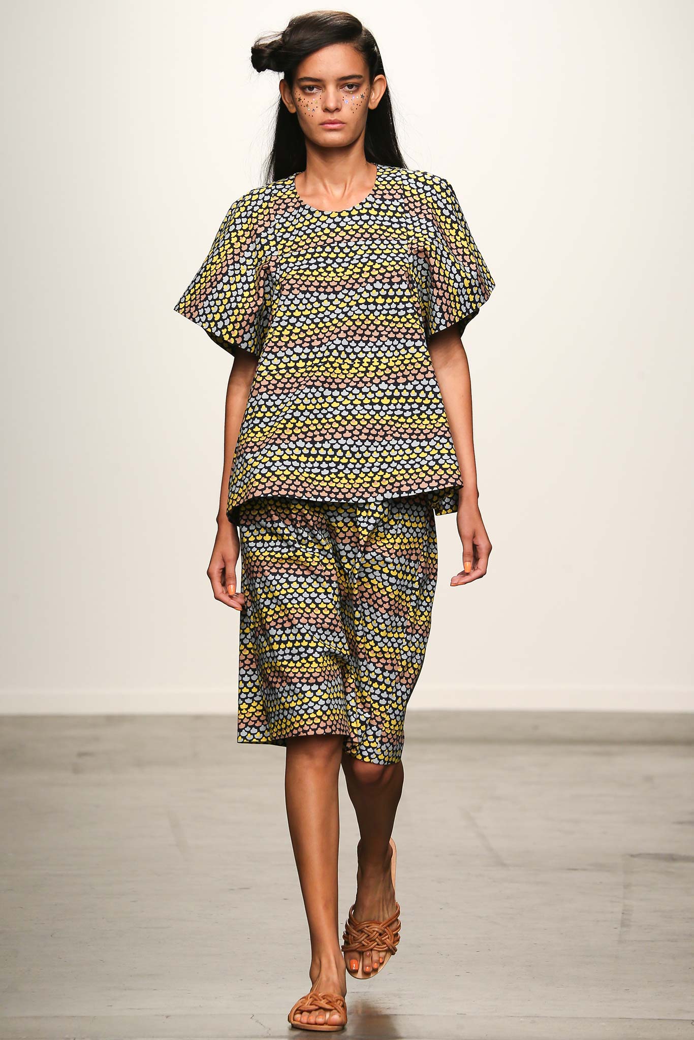 A relaxed fit multicolor cotton top with short sleeves paired with a matching skirt featuring a printed design.