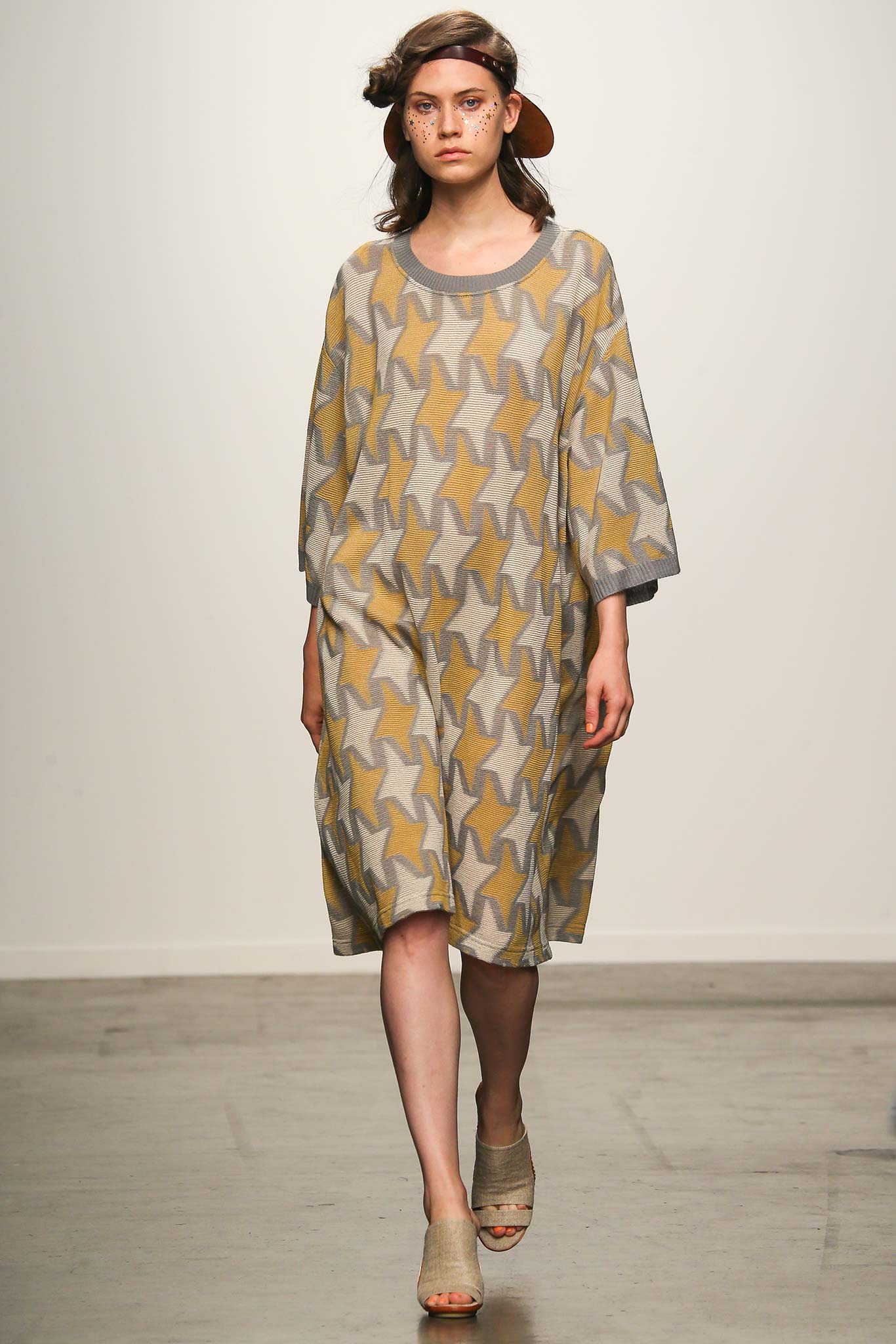 A relaxed gray and yellow printed dress with short sleeves and a collared neckline.