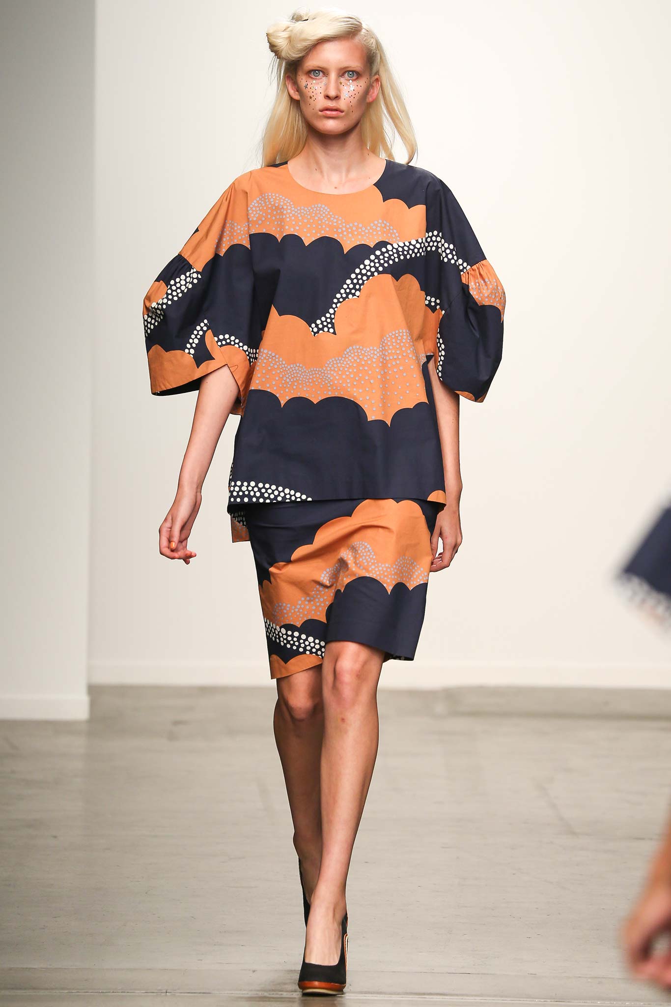 A relaxed-fit orange and navy printed top paired with a matching skirt.