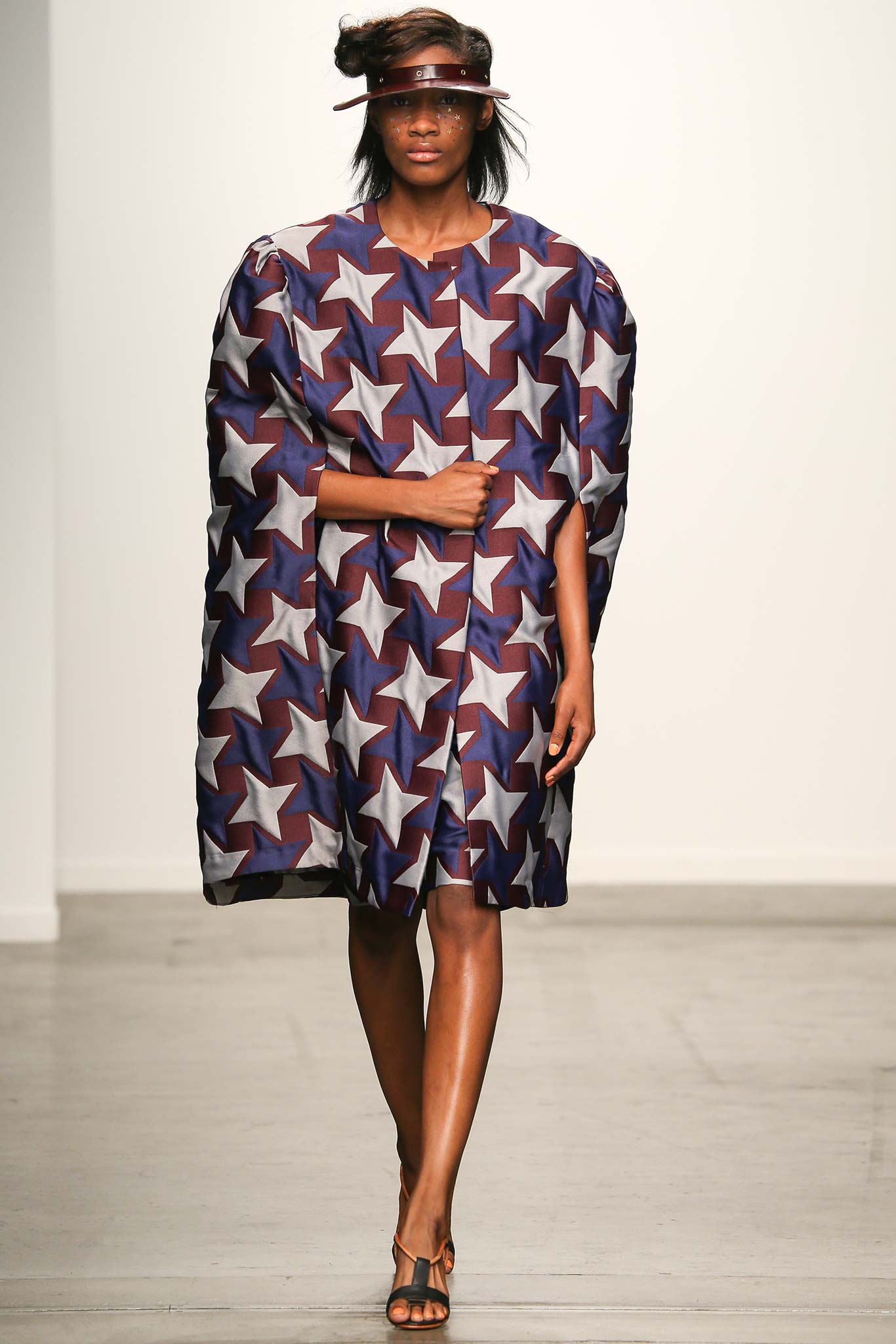 A relaxed fit sleeveless dress with a collared neckline and a printed star design.