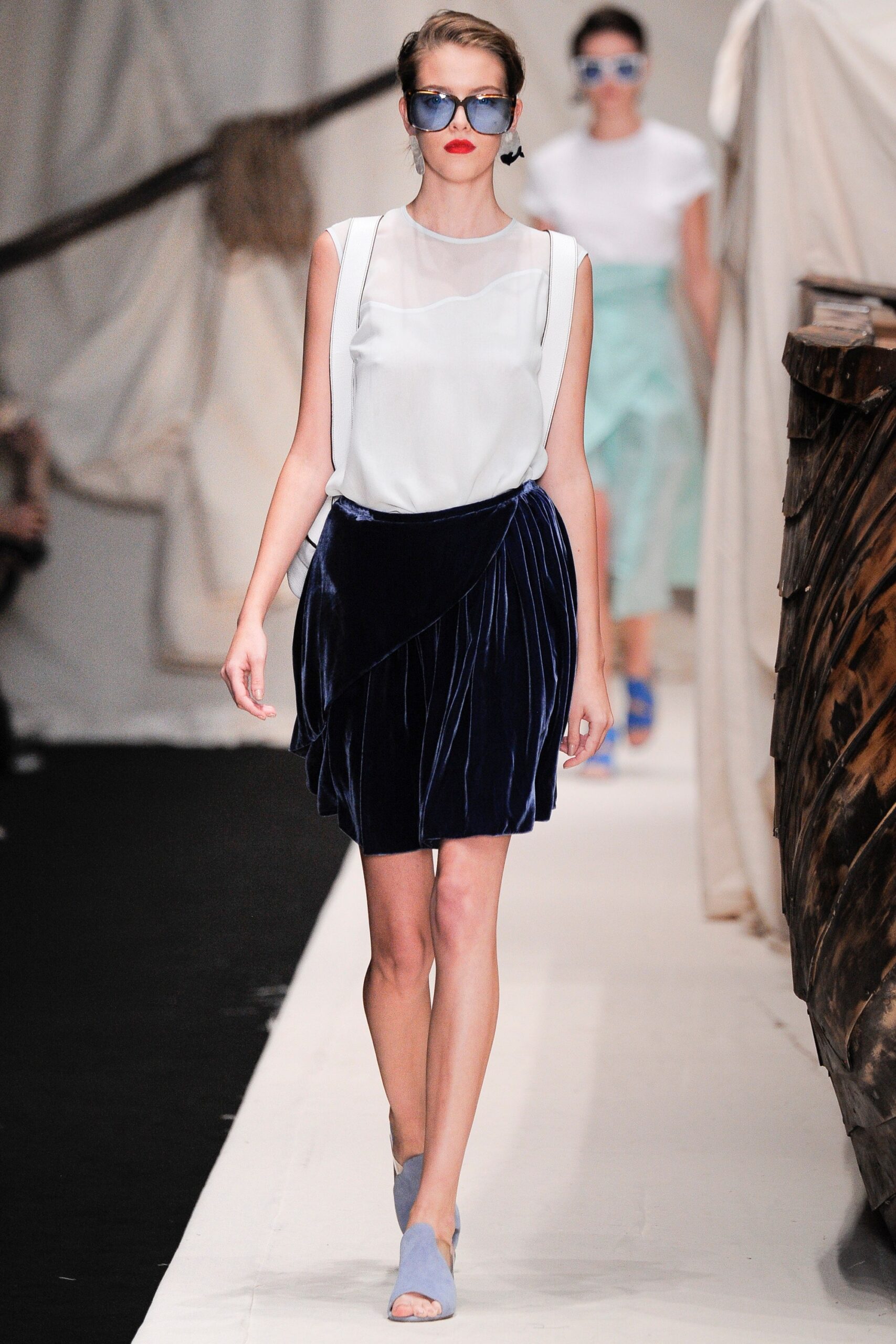 white silk sleeveless top and blue velvet skirt