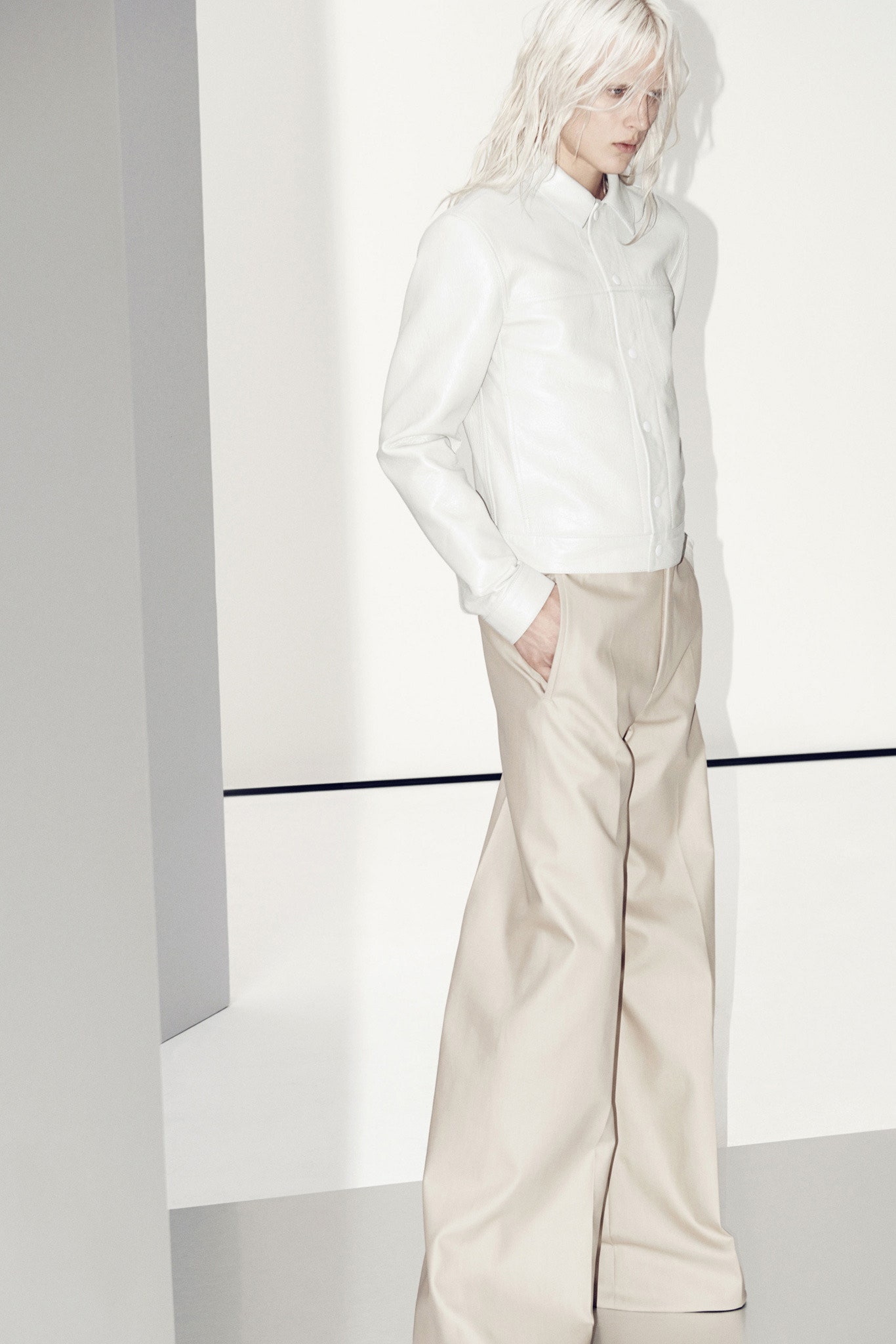 white leather fitted jacket and beige relaxed pants