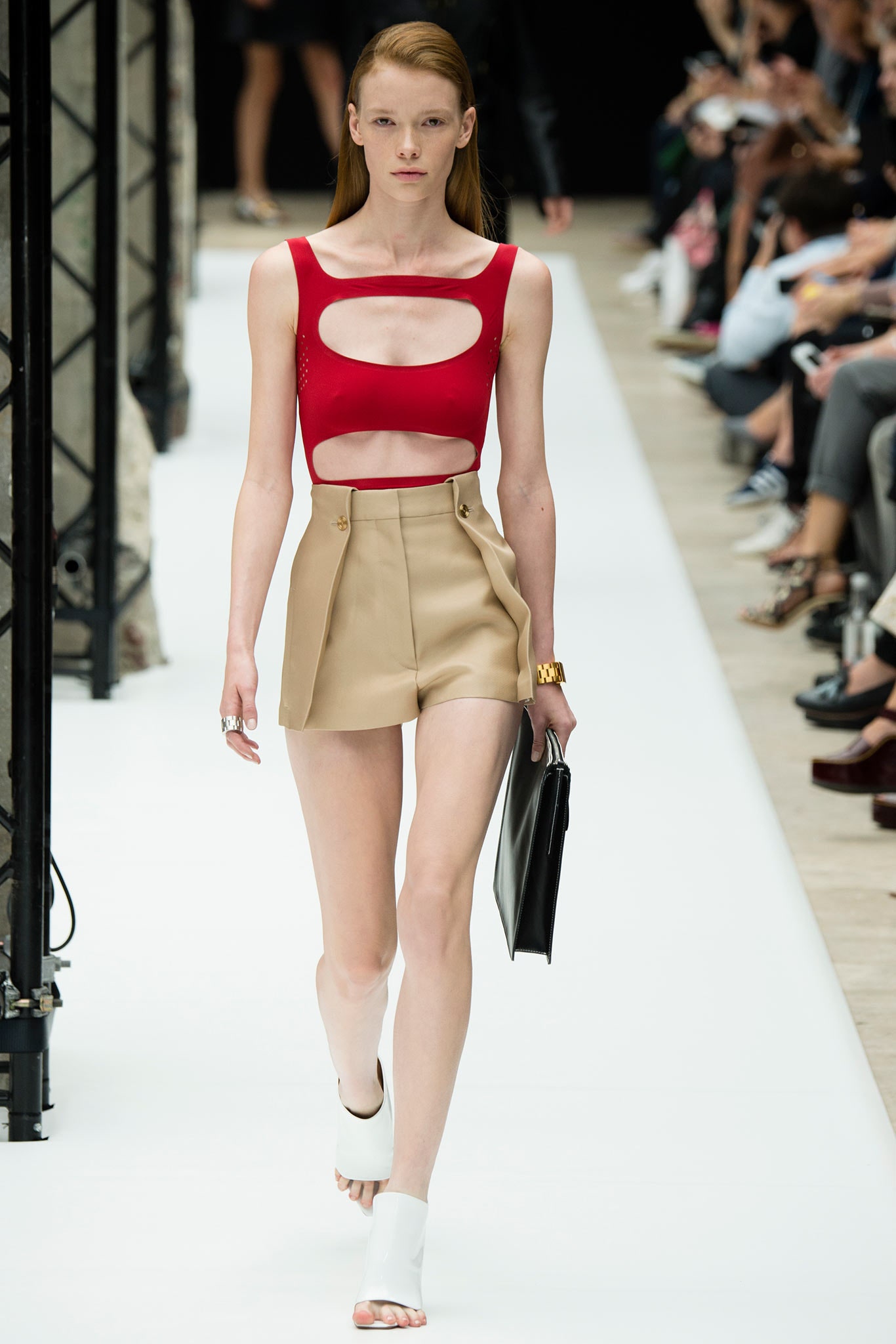 red cutout top with beige shorts