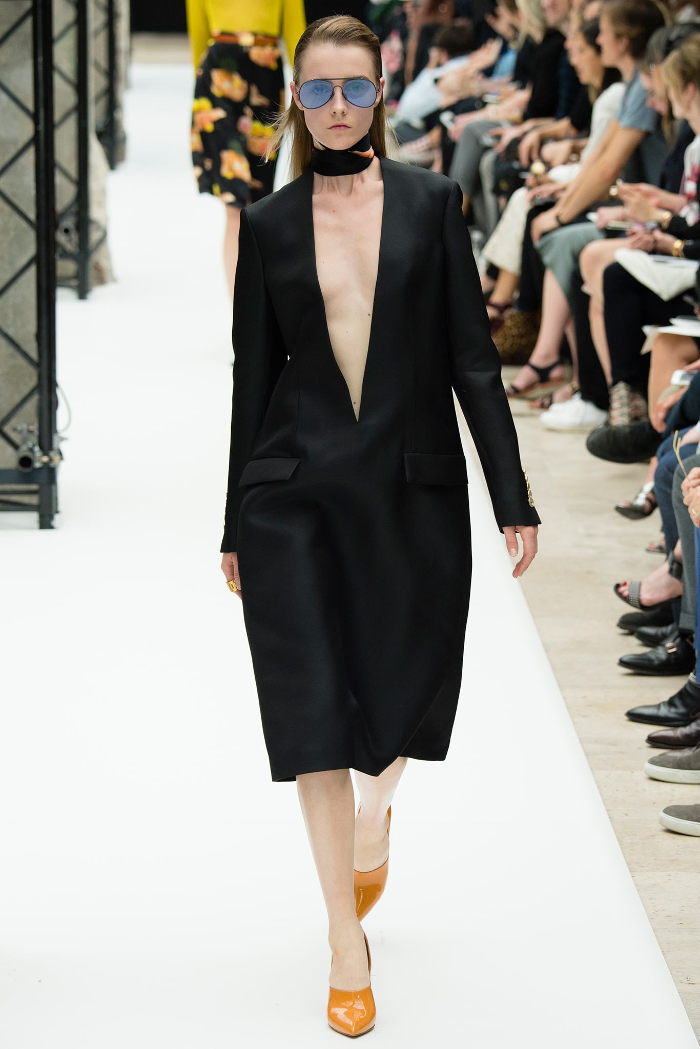 black silk fitted dress with orange shoes