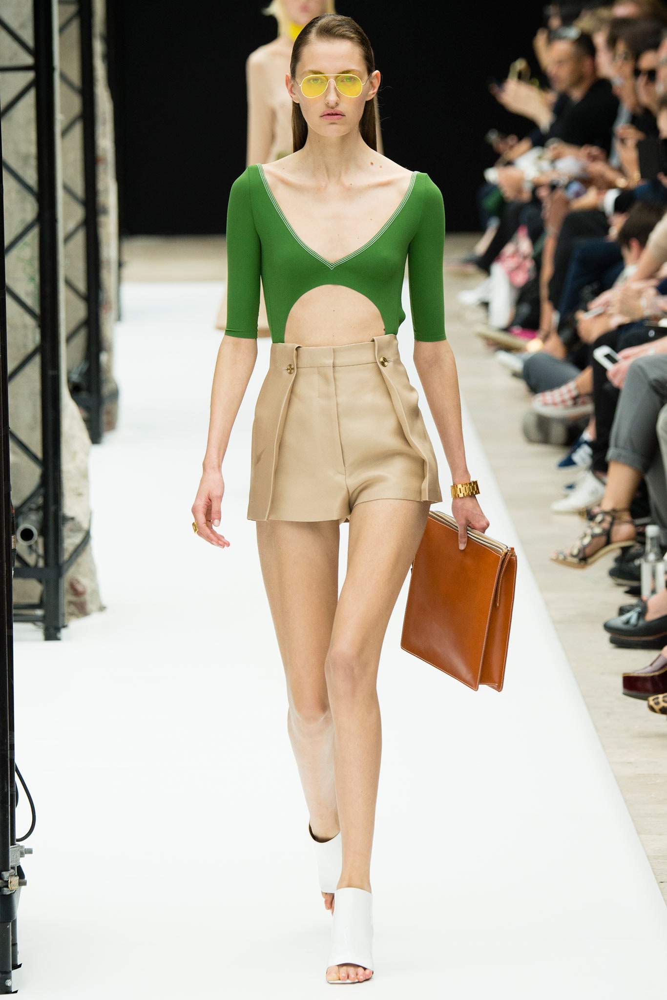 green fitted top with beige shorts