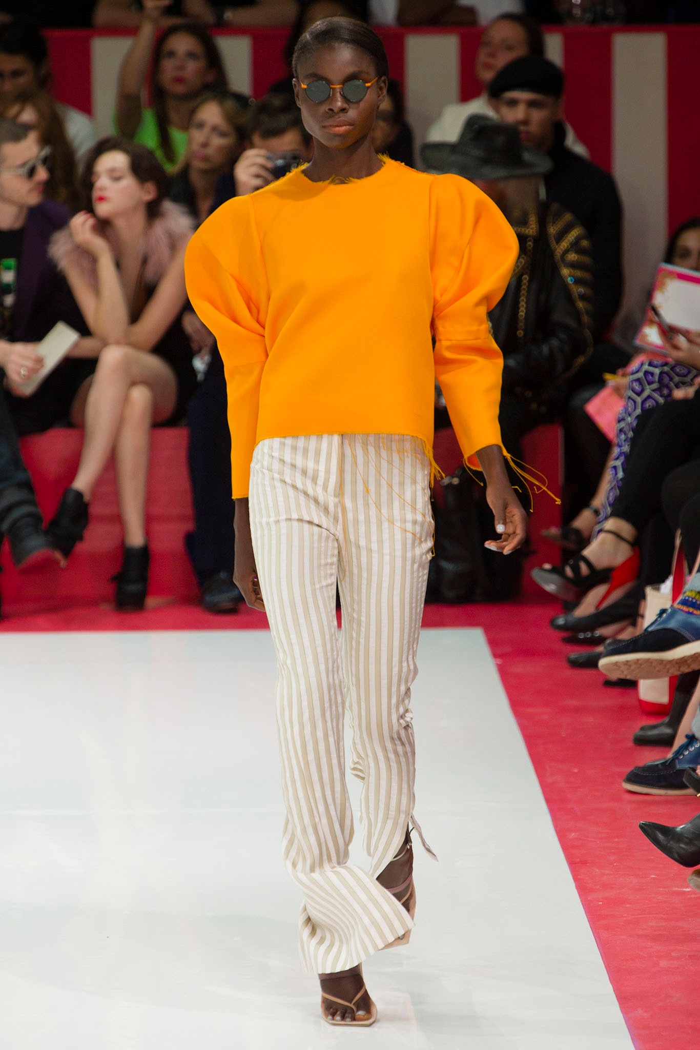 orange puffed sleeve top with striped pants